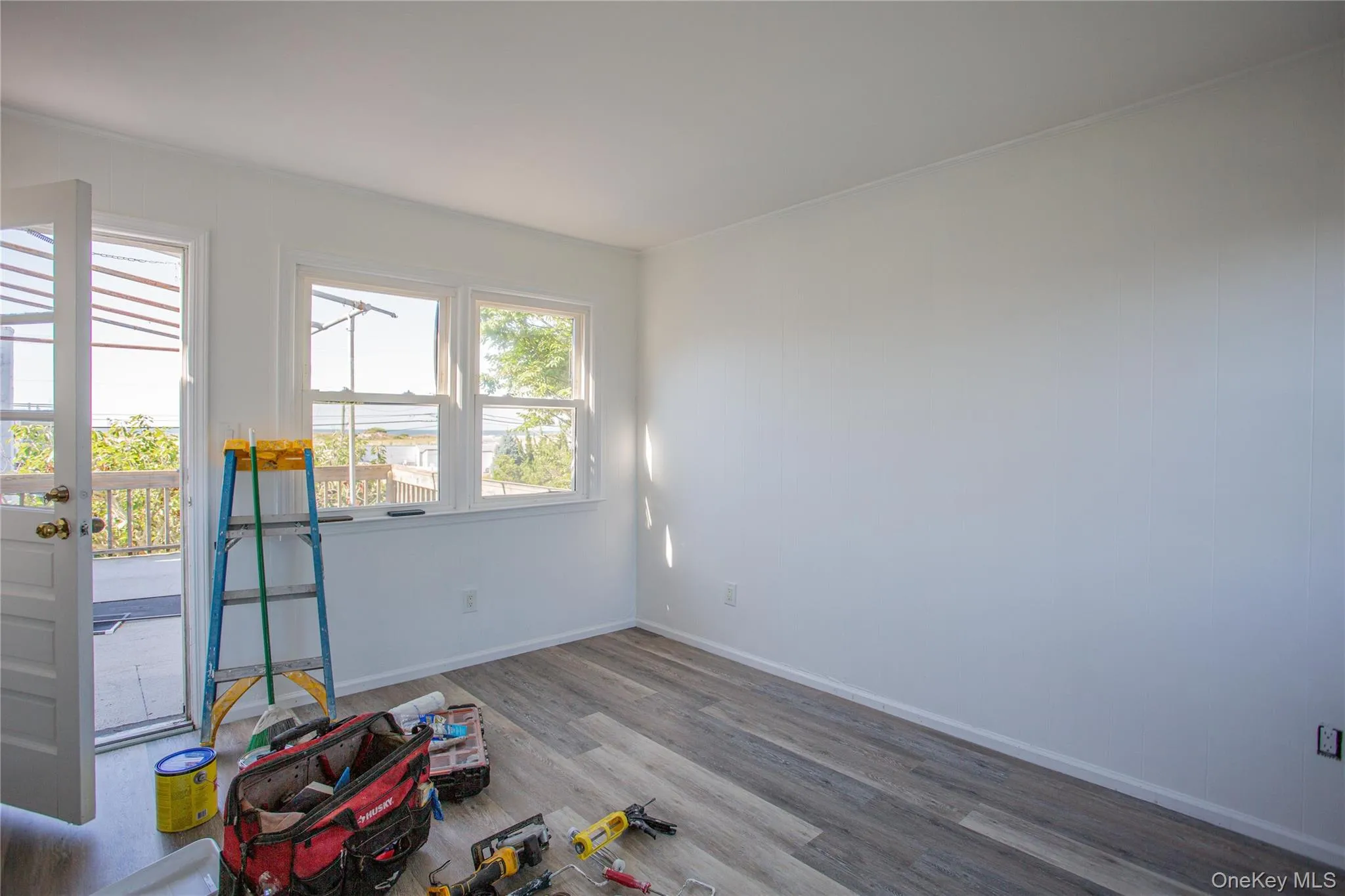 Unfurnished room featuring wood finished floors and baseboards Unfurnished room featuring wood finished floors and baseboards