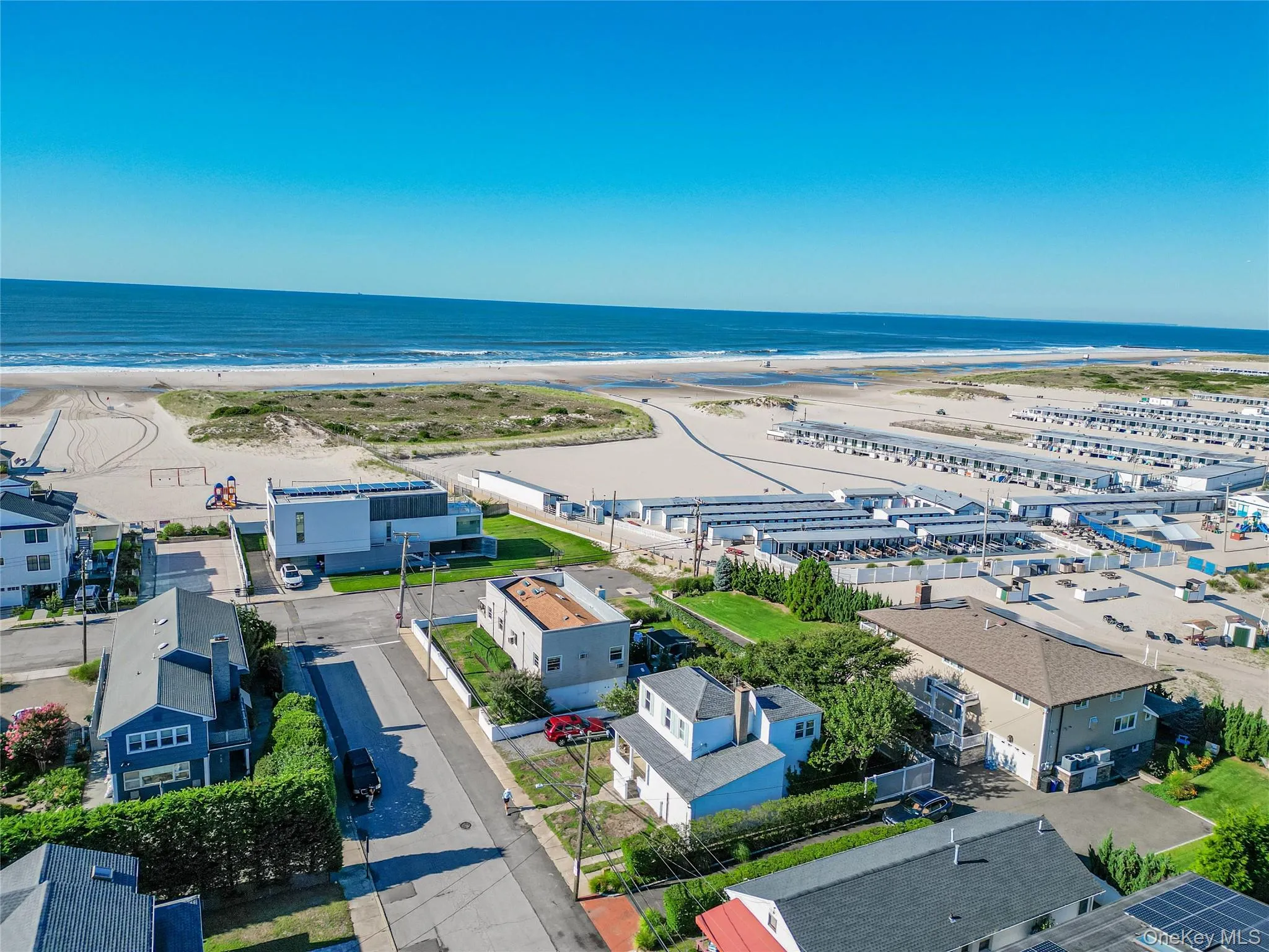 Aerial view of residential area featuring extended coastline Aerial view of residential area featuring extended coastline