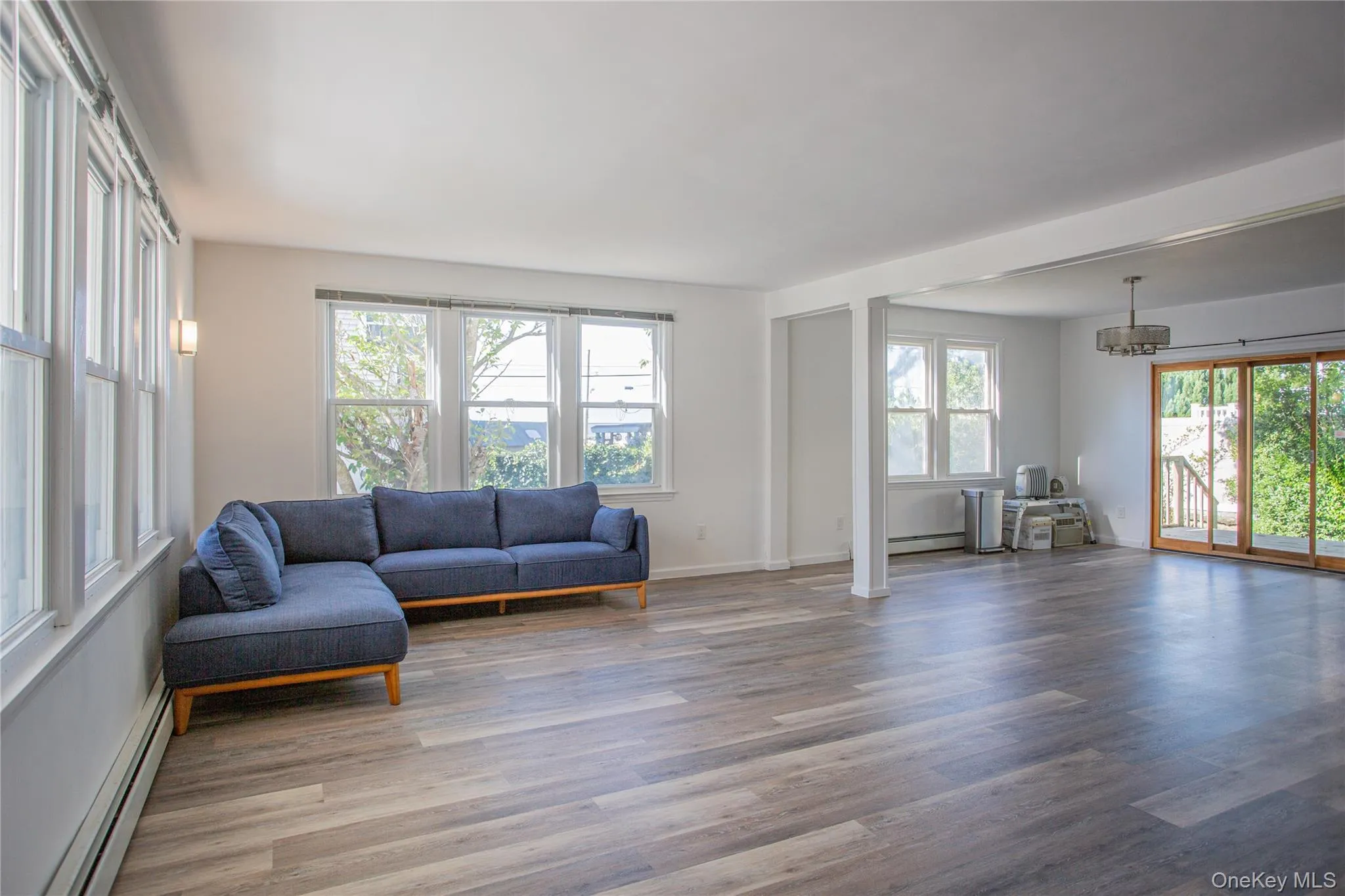 Living area with a baseboard heating unit and light wood-style floors Living area with a baseboard heating unit and light wood-style floors
