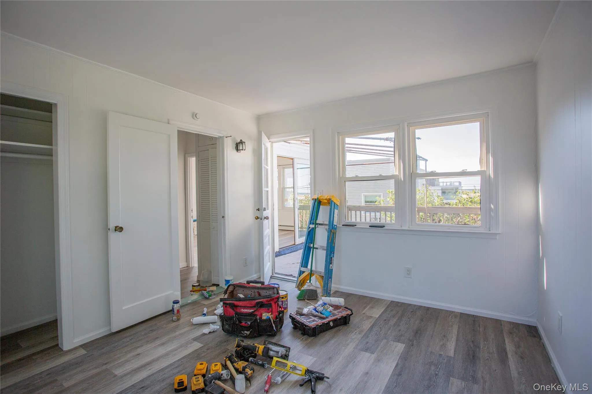 Bedroom with dark wood-style flooring and baseboards Bedroom with dark wood-style flooring and baseboards