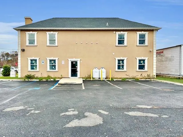 View of property with uncovered parking View of property with uncovered parking
