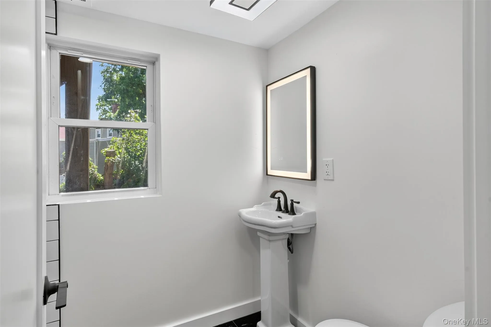 Bathroom featuring toilet and baseboards Bathroom featuring toilet and baseboards