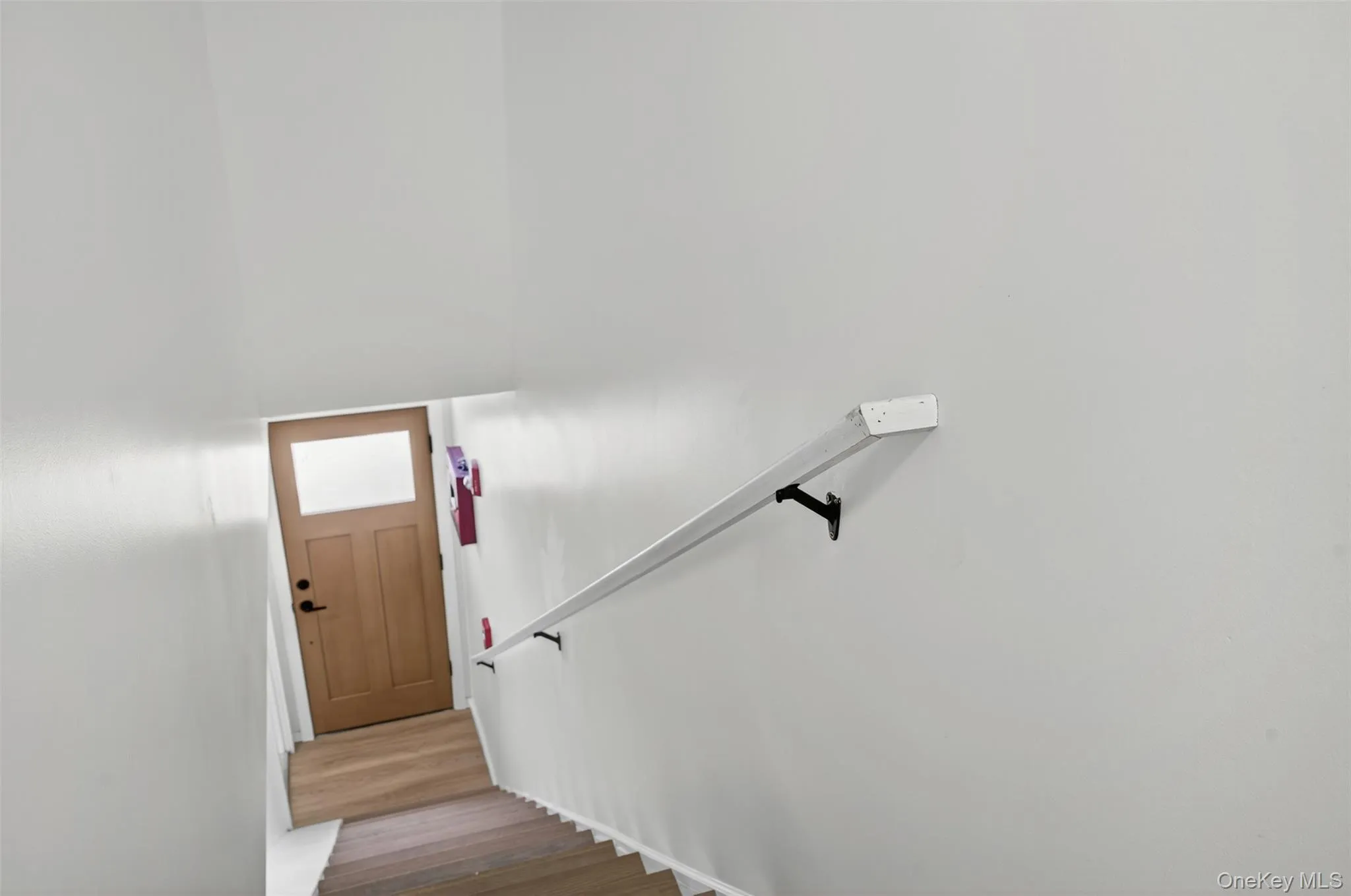 Stairs featuring wood finished floors Stairs featuring wood finished floors