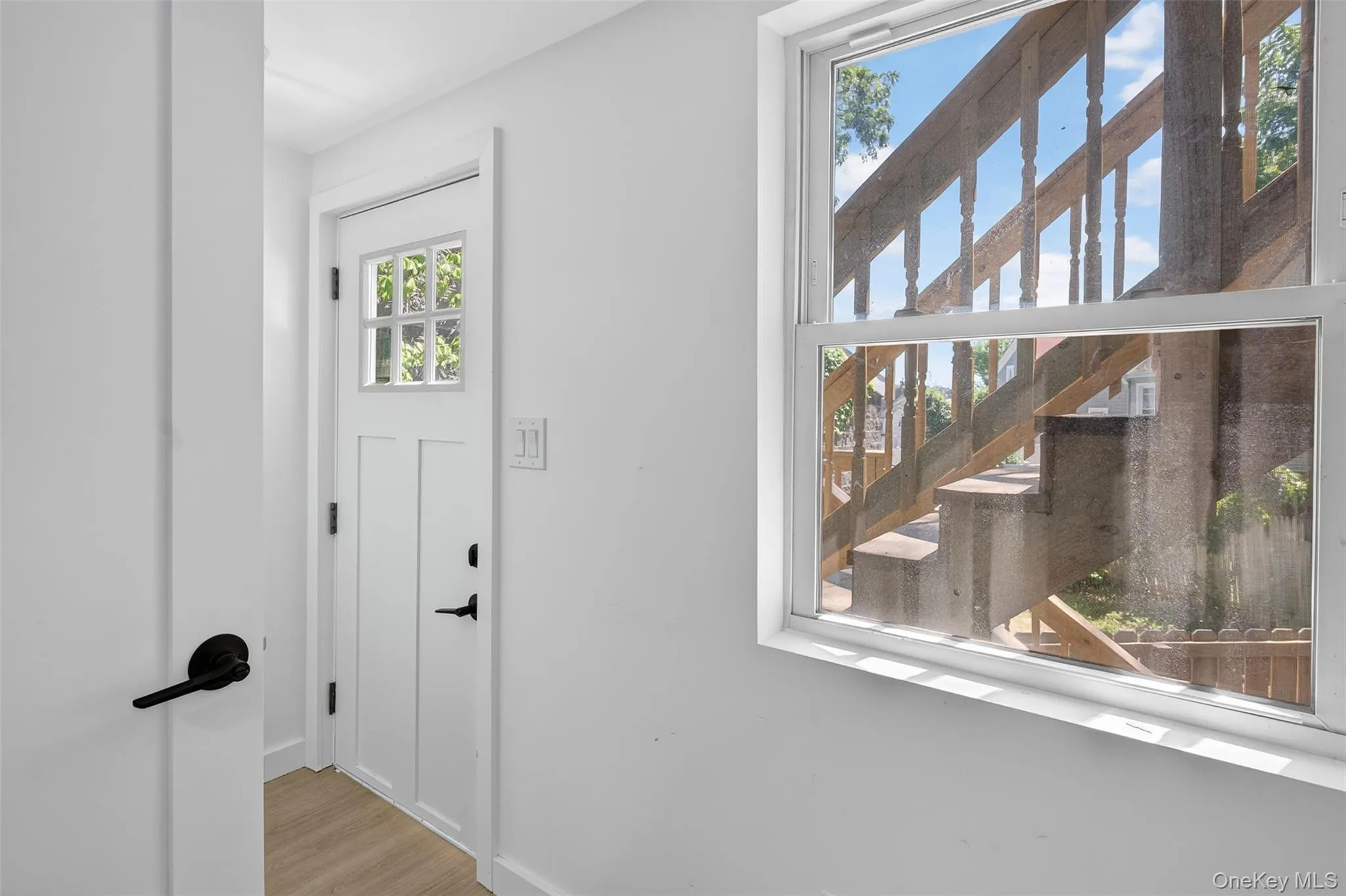 Entryway featuring wood finished floors and baseboards Entryway featuring wood finished floors and baseboards