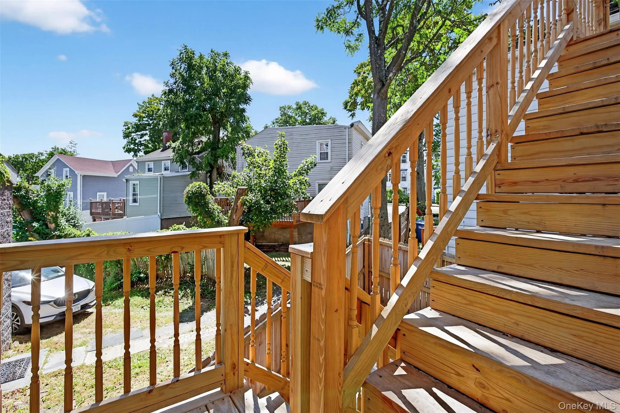 Wooden deck with stairs and a residential view Wooden deck with stairs and a residential view