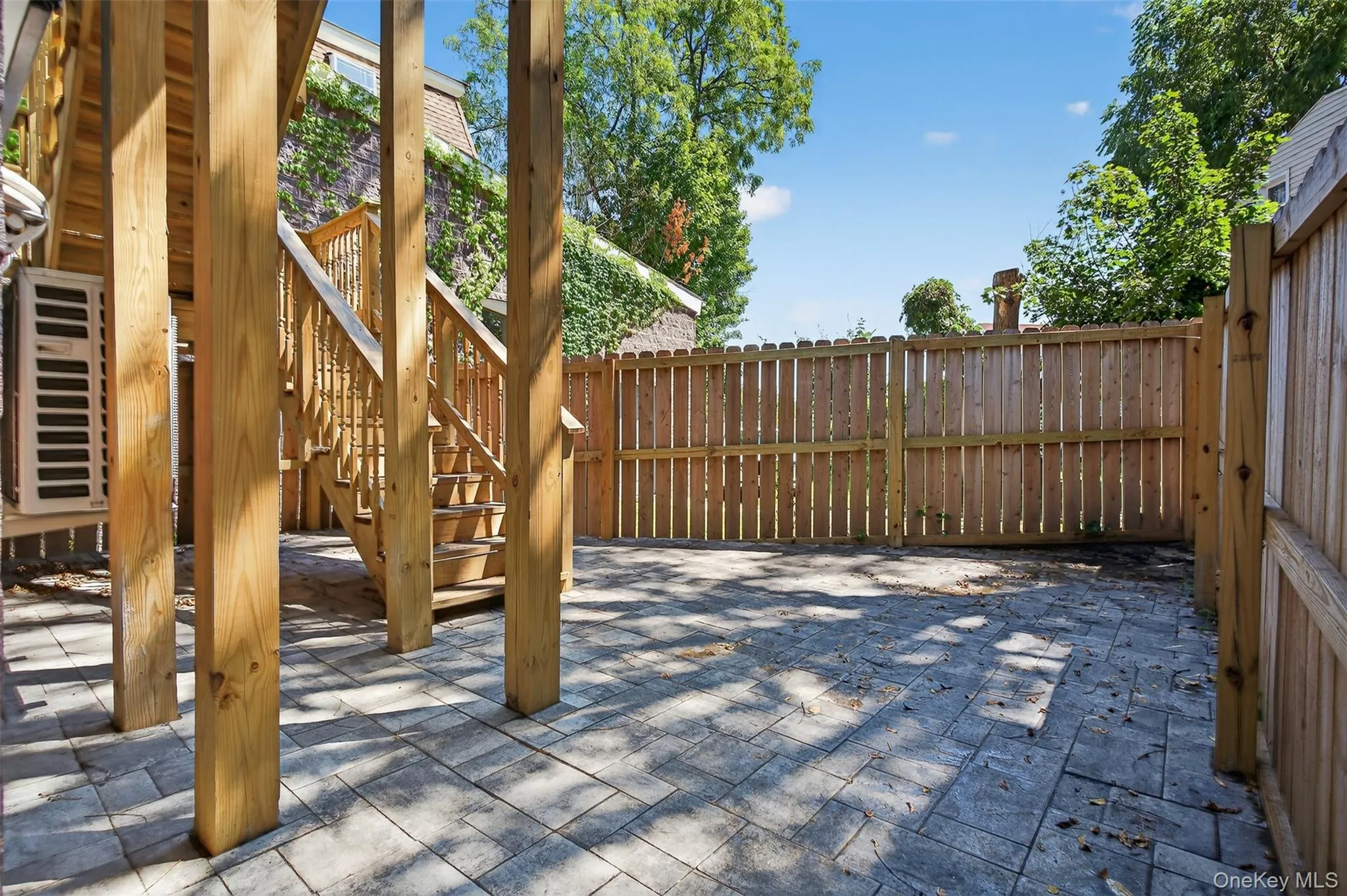 Fenced backyard featuring stairway and a patio area Fenced backyard featuring stairway and a patio area