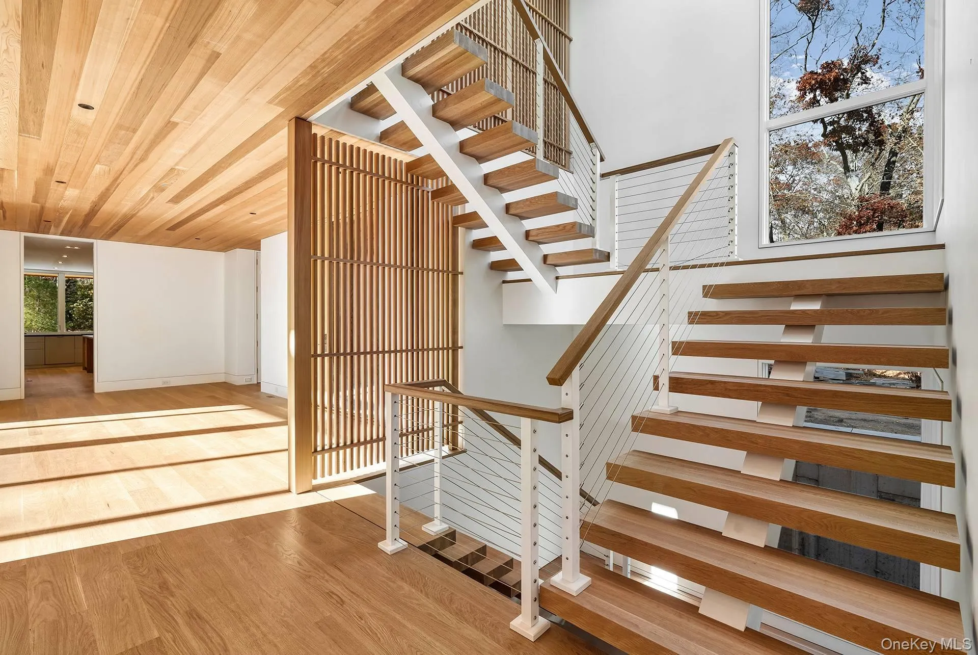 Stairway featuring wood finished floors and wood ceiling Stairway featuring wood finished floors and wood ceiling