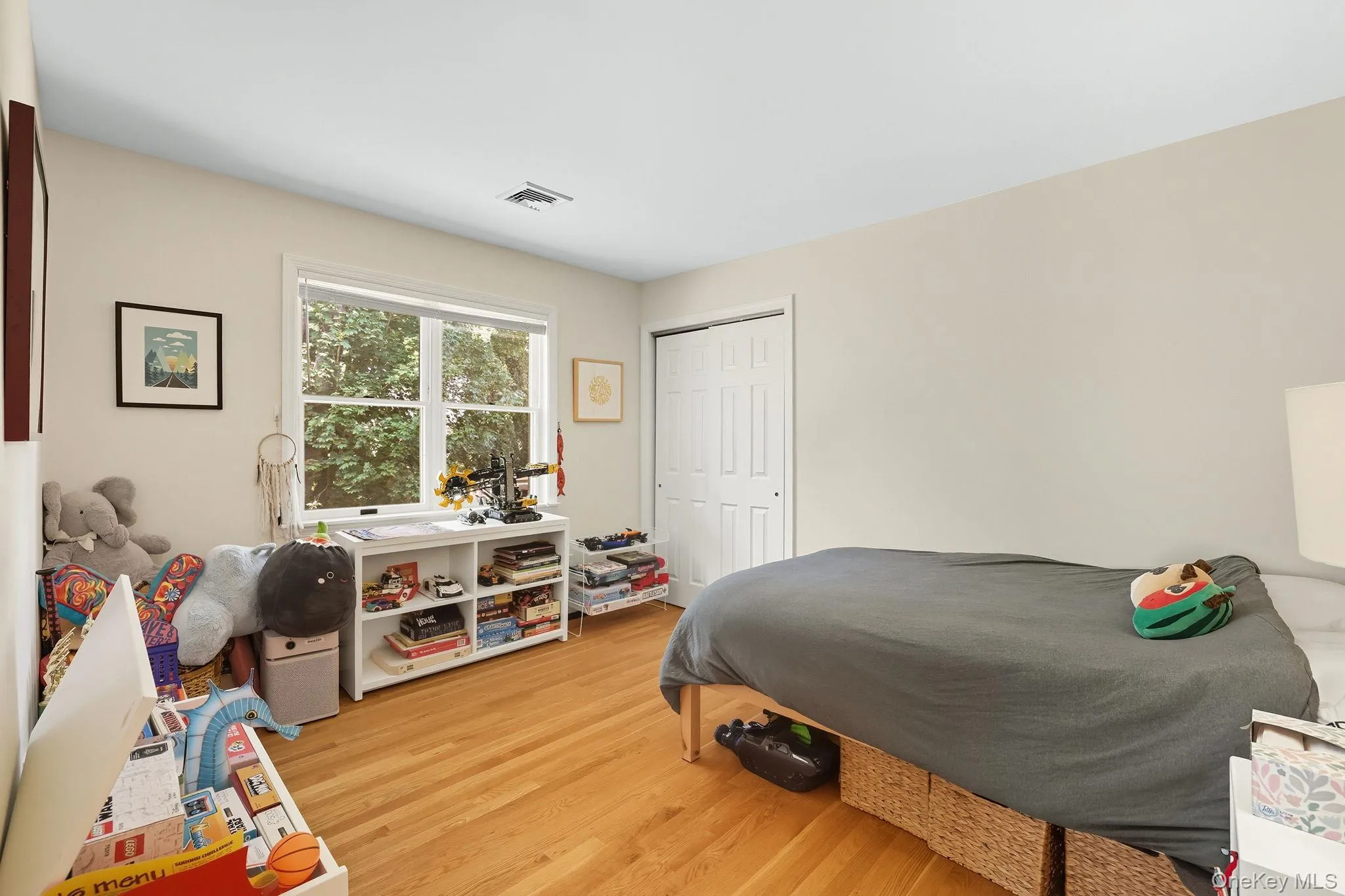 Bedroom with hardwood floors and a double closet Bedroom with hardwood floors and a double closet