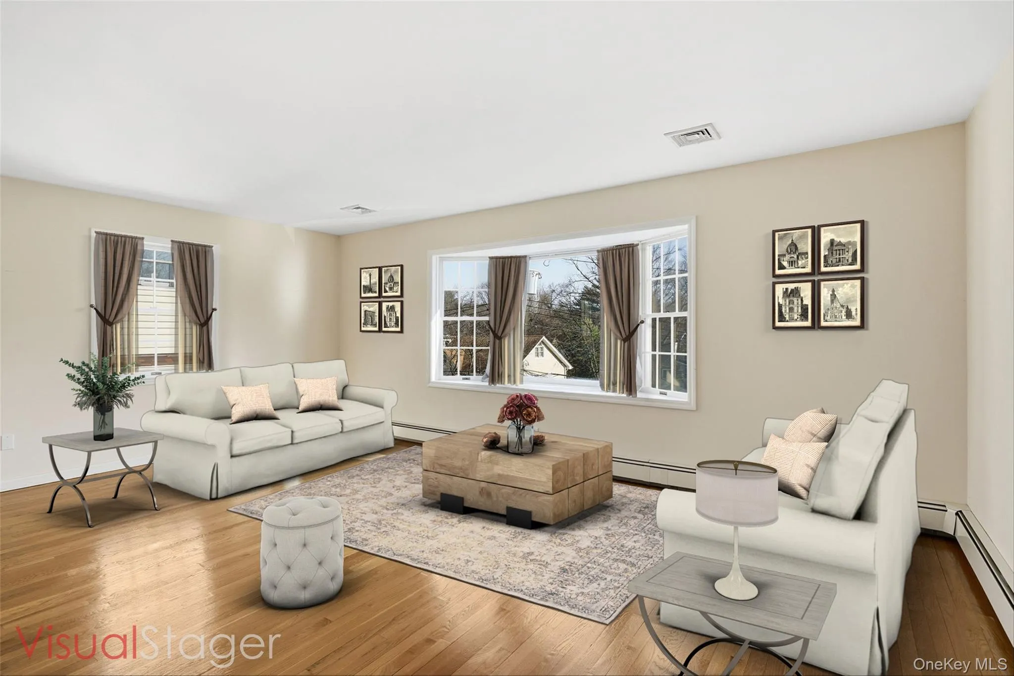 Living room with hardwood floors, bay window, and ample natural light Living room with hardwood floors, bay window, and ample natural light