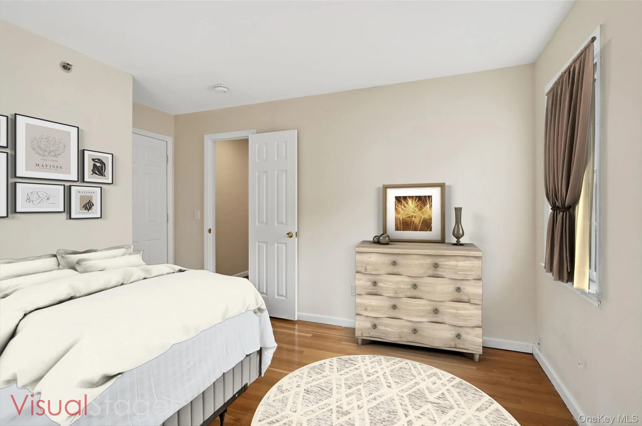 Bedroom with hardwood floors and a double closet Bedroom with hardwood floors and a double closet