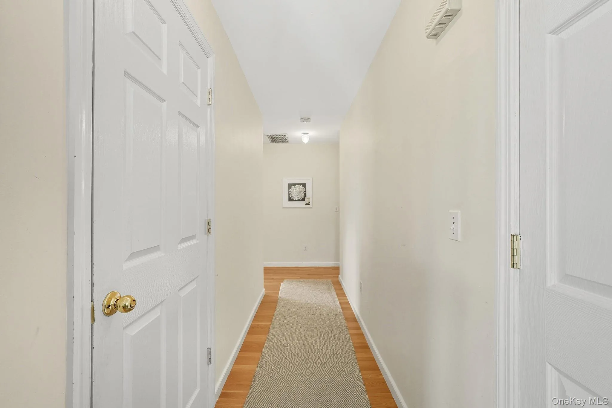 Hall featuring light wood floors Hall featuring light wood floors