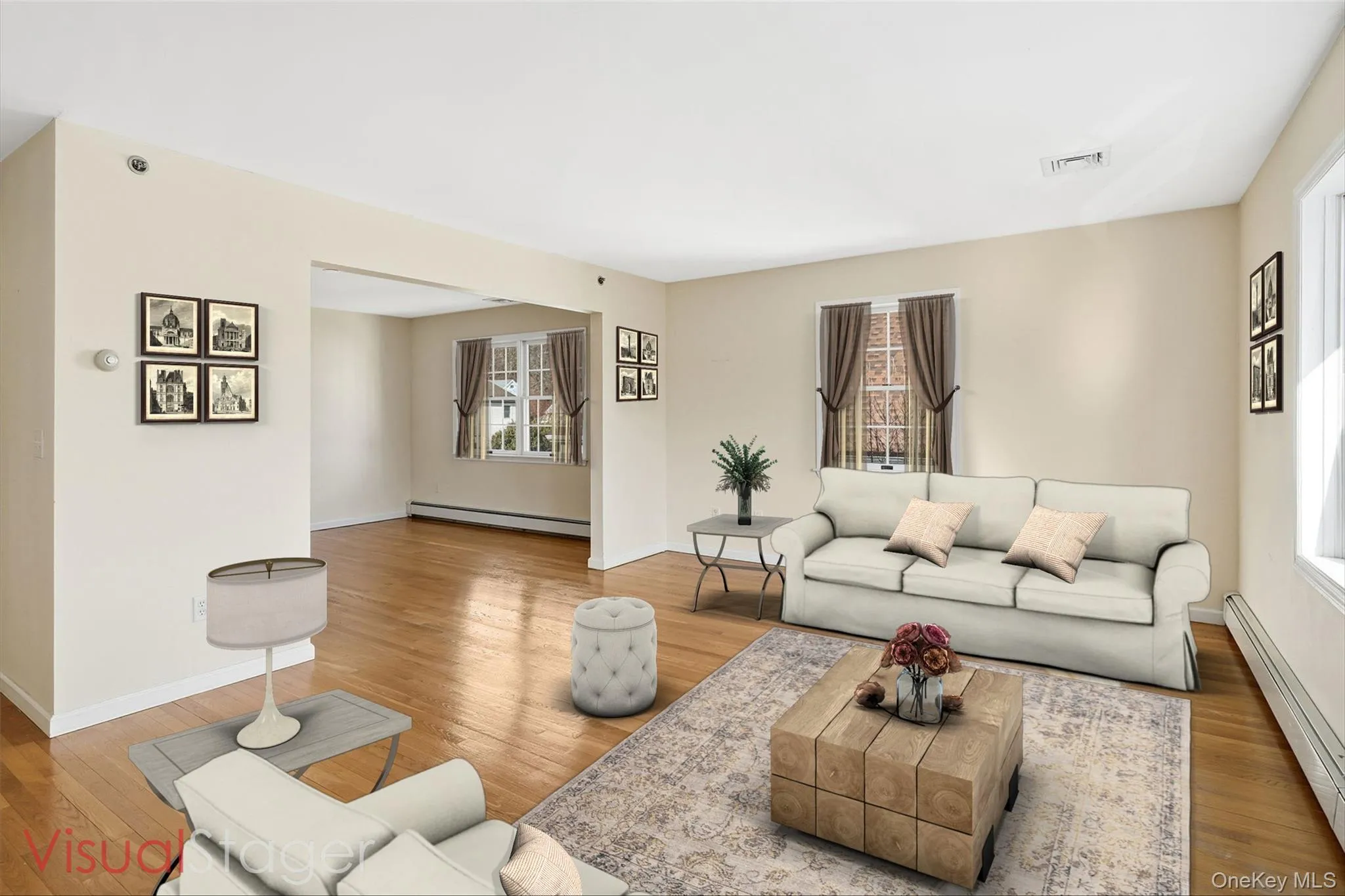Living room with hardwood floors, bay window, and ample natural light Living room with hardwood floors, bay window, and ample natural light