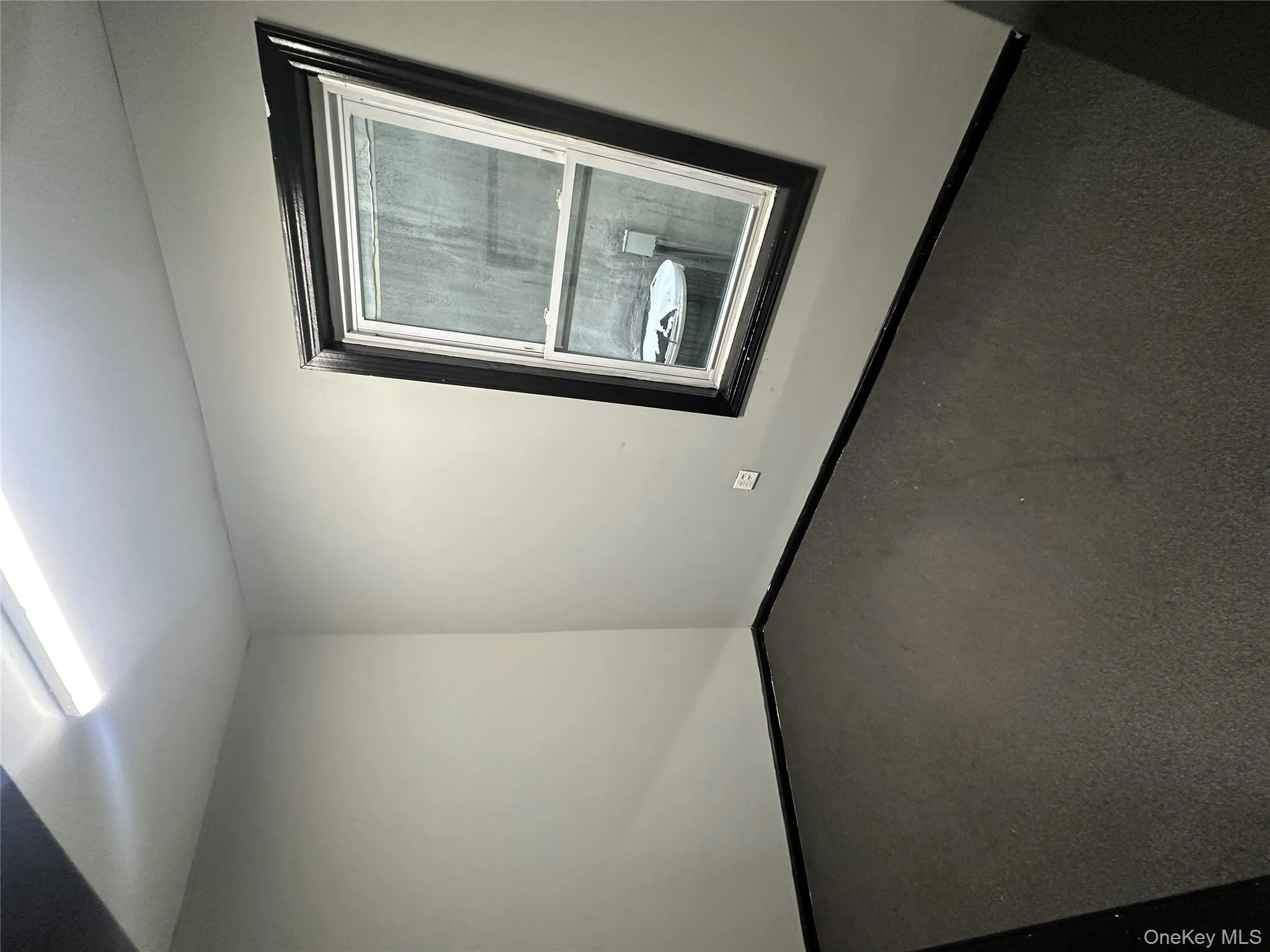 Carpeted spare room featuring baseboards Carpeted spare room featuring baseboards