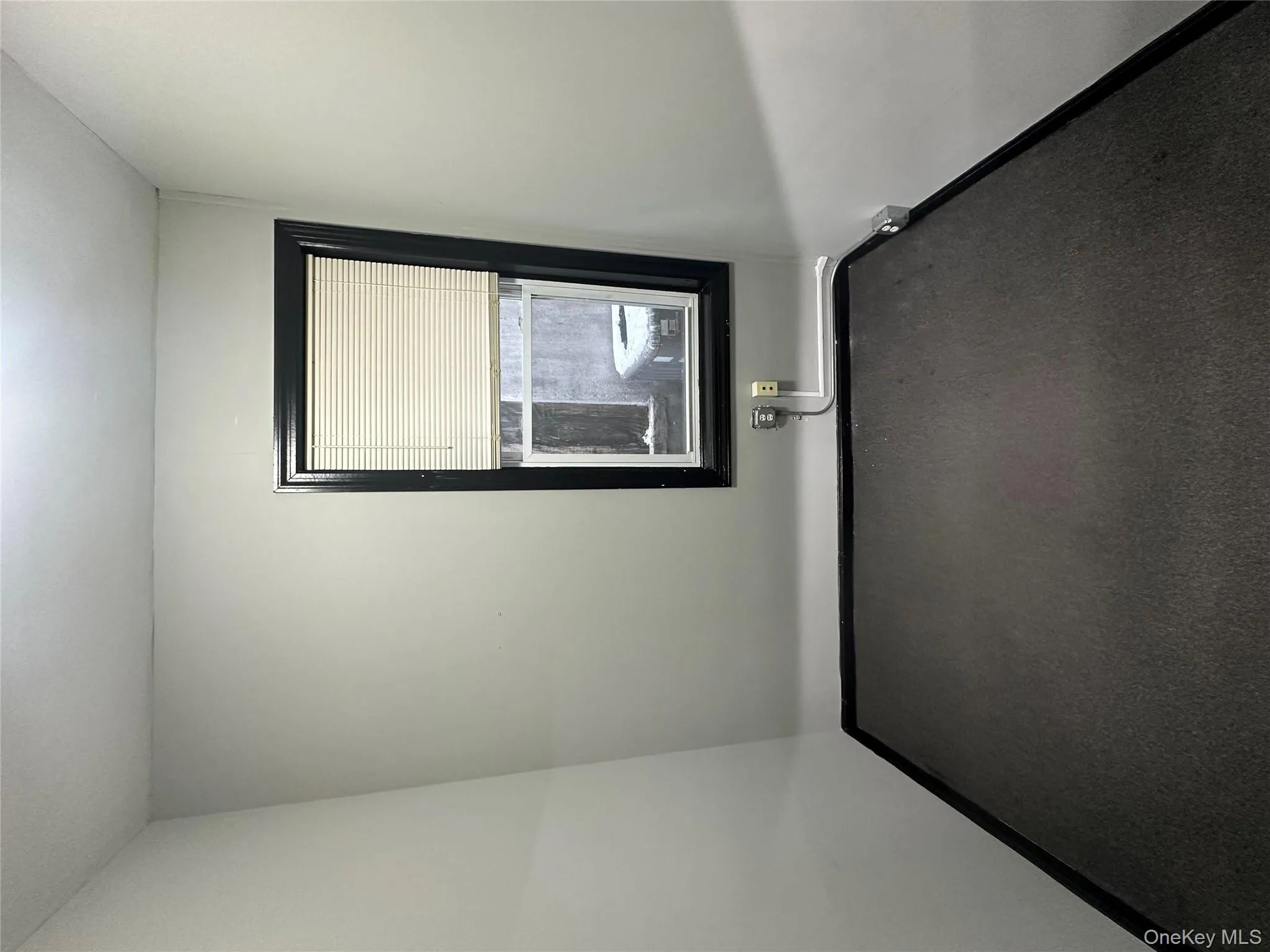 Carpeted empty room featuring baseboards Carpeted empty room featuring baseboards