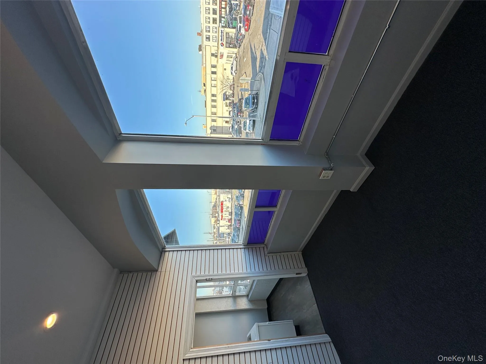 Empty room featuring baseboards and dark carpet Empty room featuring baseboards and dark carpet