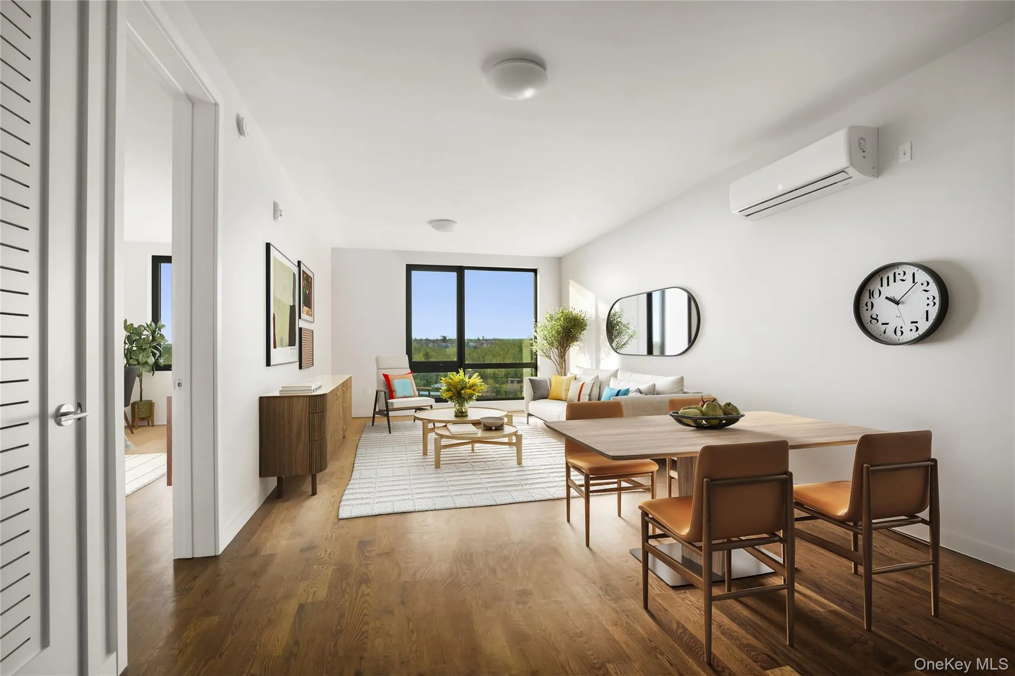 Dining area with a wall unit AC, dark wood-type flooring, and baseboards Dining area with a wall unit AC, dark wood-type flooring, and baseboards