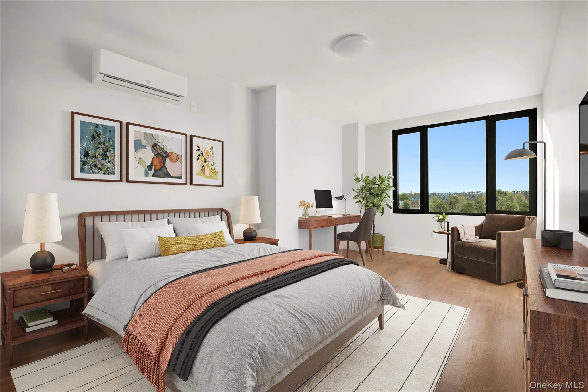 Bedroom with a wall mounted AC, light wood-type flooring, an office area, and baseboards Bedroom with a wall mounted AC, light wood-type flooring, an office area, and baseboards