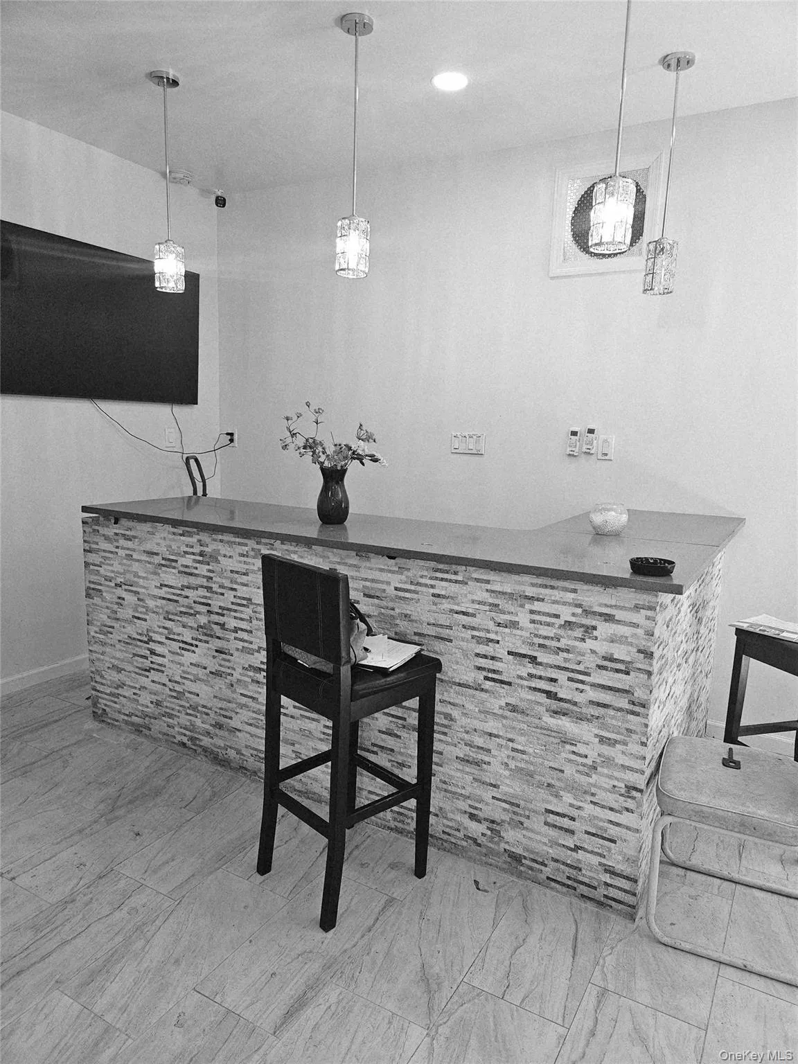 Indoor dry bar with decorative light fixtures and baseboards Indoor dry bar with decorative light fixtures and baseboards