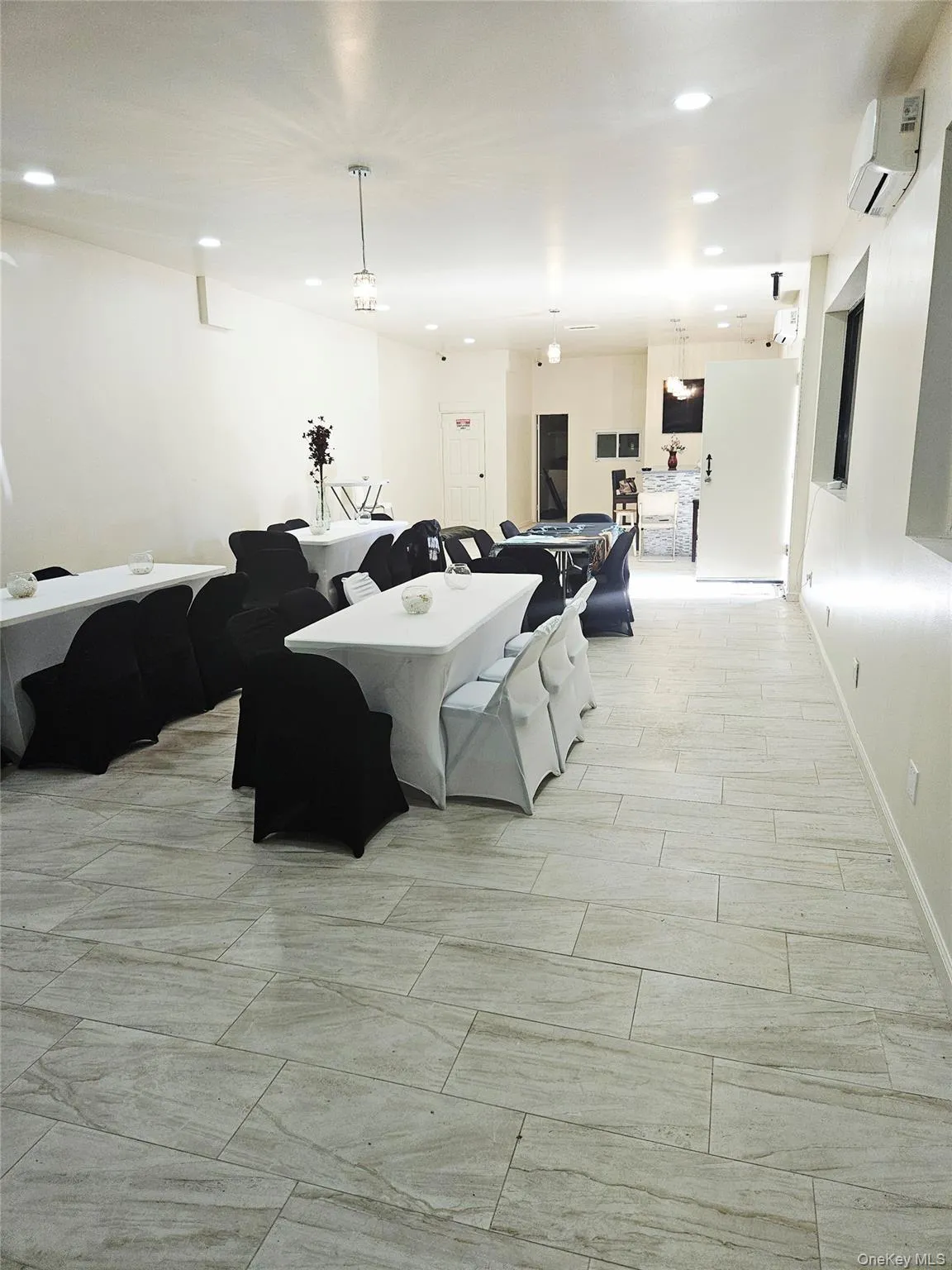 Living area featuring recessed lighting, wood tiled floors, and a wall mounted AC Living area featuring recessed lighting, wood tiled floors, and a wall mounted AC