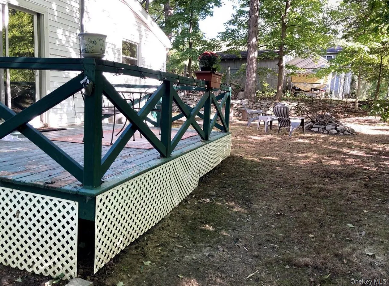Gate featuring a deck and a fire pit Gate featuring a deck and a fire pit
