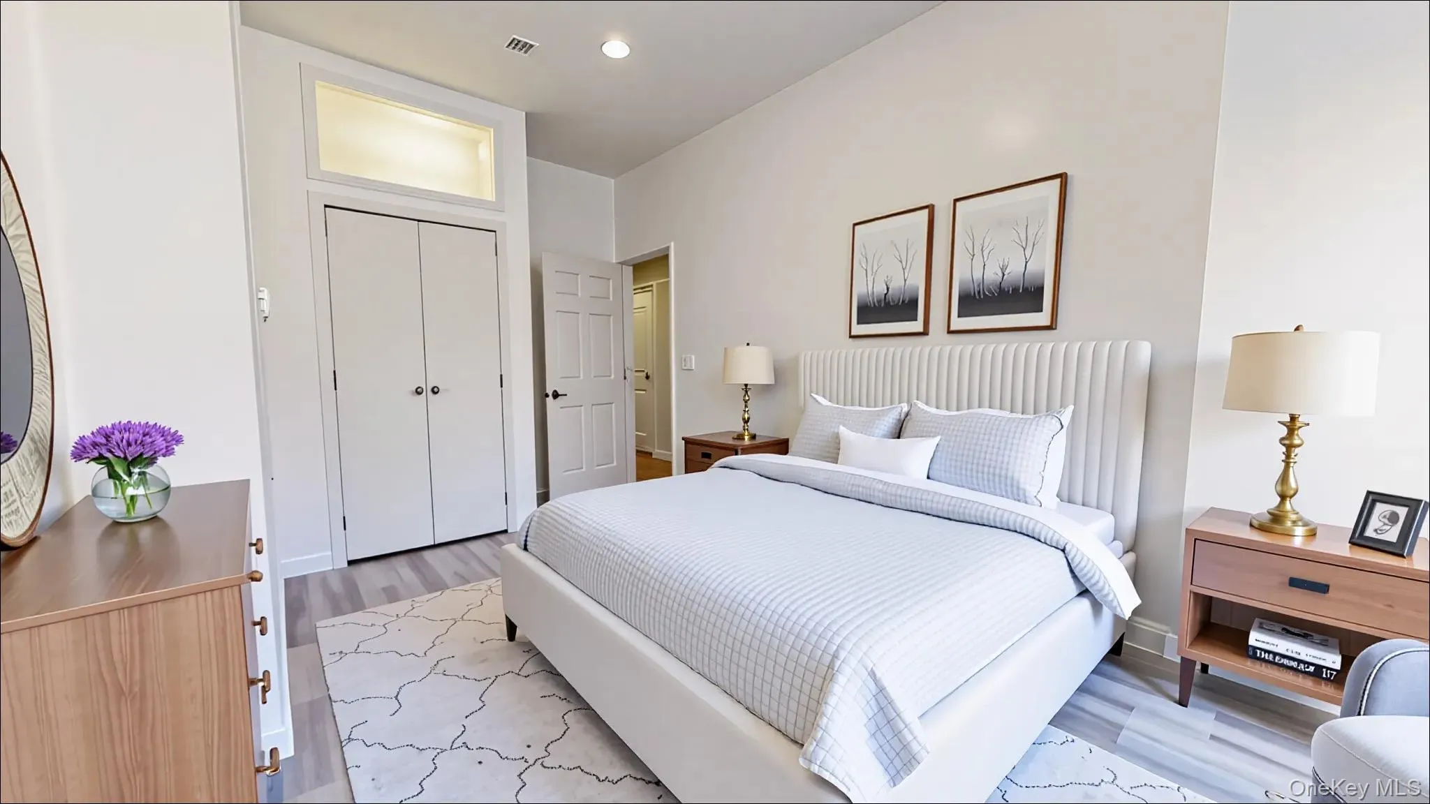 Bedroom featuring light wood-style flooring, recessed lighting, and a closet Bedroom featuring light wood-style flooring, recessed lighting, and a closet