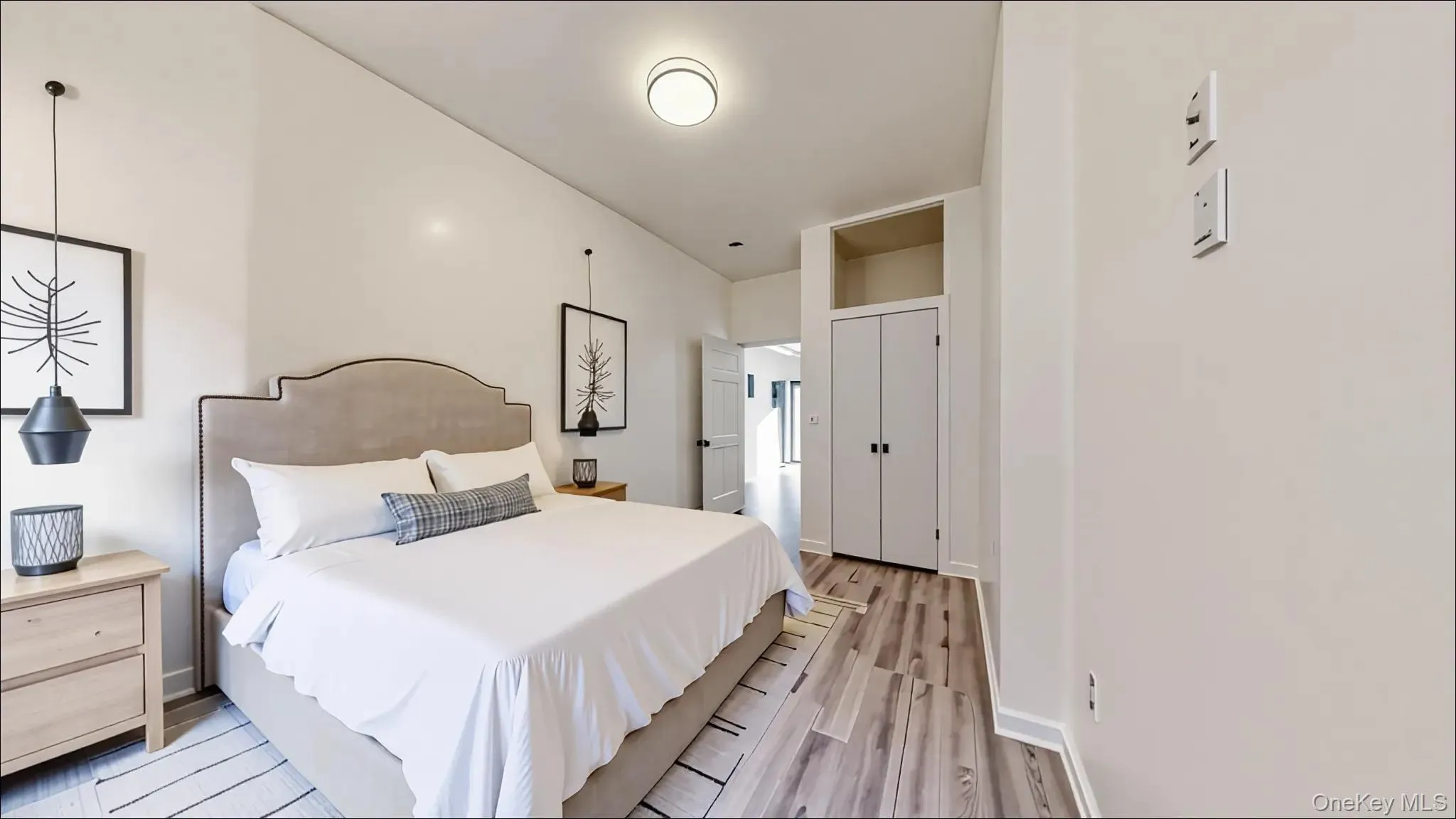 Bedroom with light wood-style floors and baseboards Bedroom with light wood-style floors and baseboards