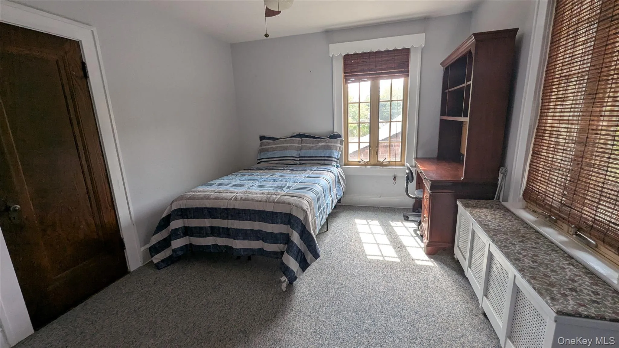 Bedroom with light colored carpet and ceiling fan Bedroom with light colored carpet and ceiling fan