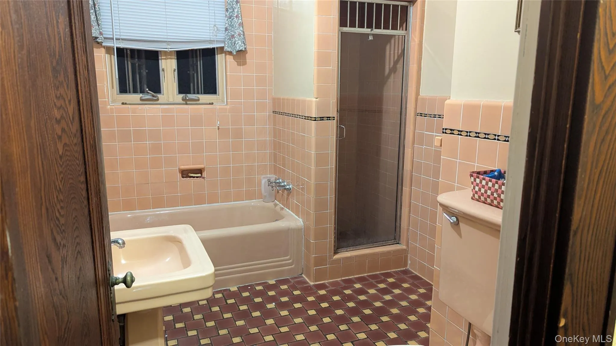 Full bathroom with tile walls and enclosed tub / shower combo Full bathroom with tile walls and enclosed tub / shower combo