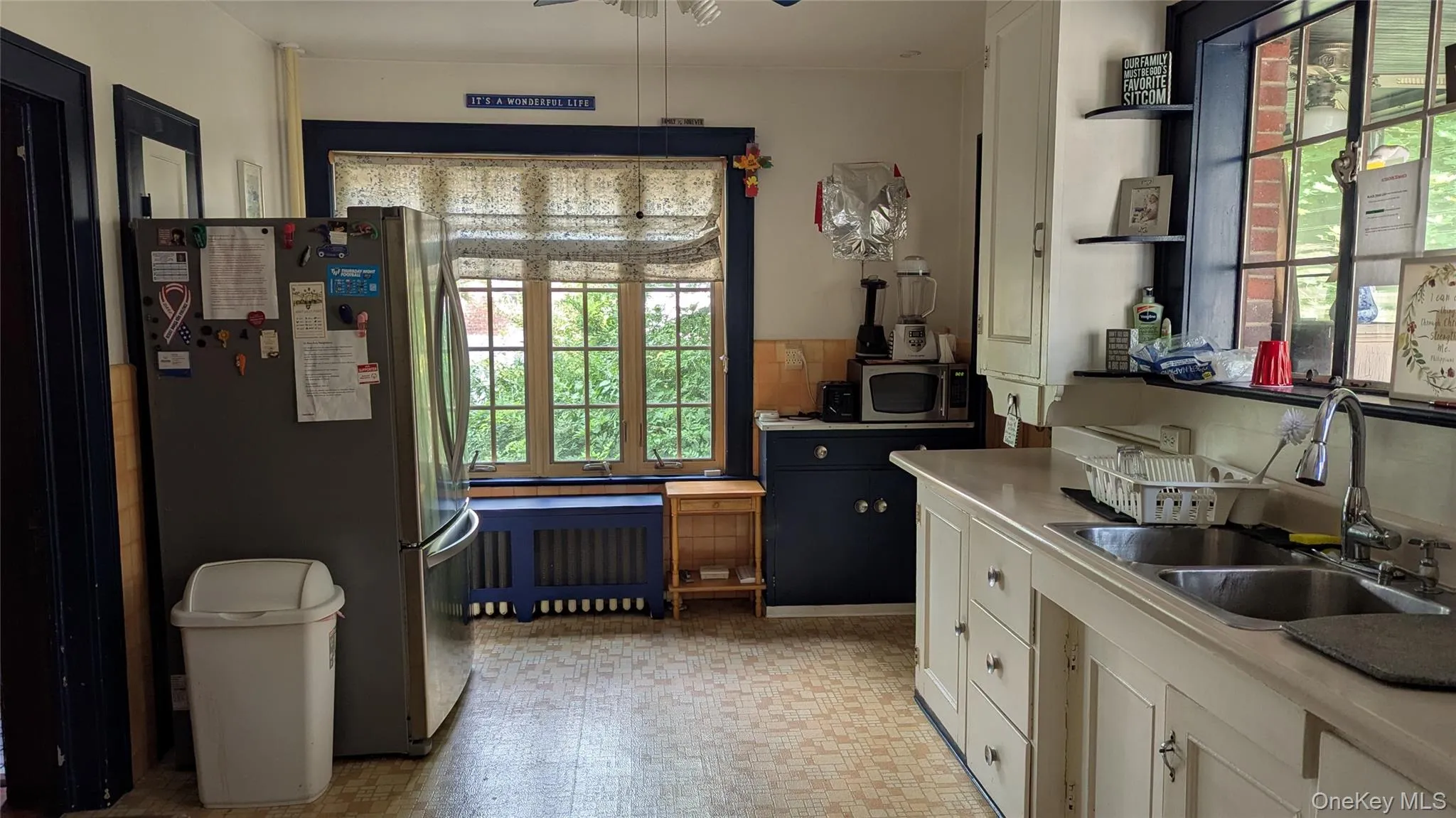 Kitchen featuring open shelves, appliances with stainless steel finishes, light countertops, and healthy amount of natural light Kitchen featuring open shelves, appliances with stainless steel finishes, light countertops, and healthy amount of natural light
