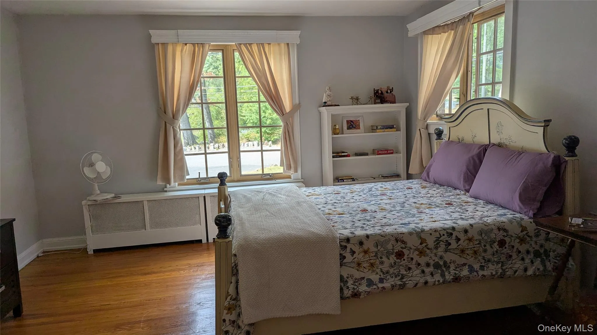 Bedroom with wood finished floors and radiator Bedroom with wood finished floors and radiator
