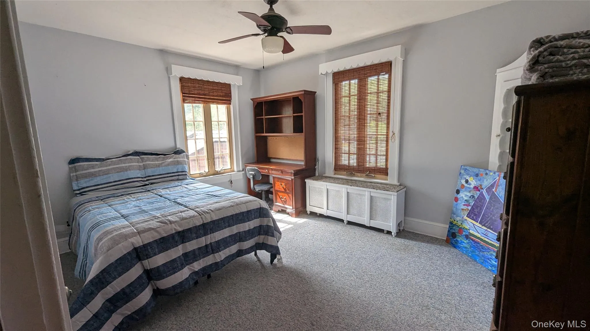 Bedroom featuring light colored carpet and ceiling fan Bedroom featuring light colored carpet and ceiling fan
