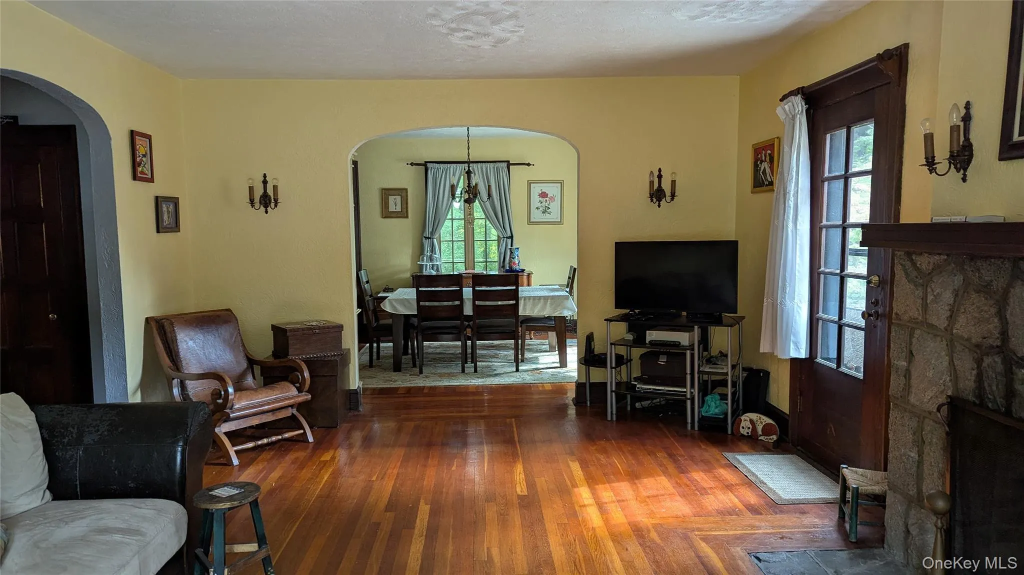 Living area featuring hardwood / wood-style floors and arched walkways Living area featuring hardwood / wood-style floors and arched walkways