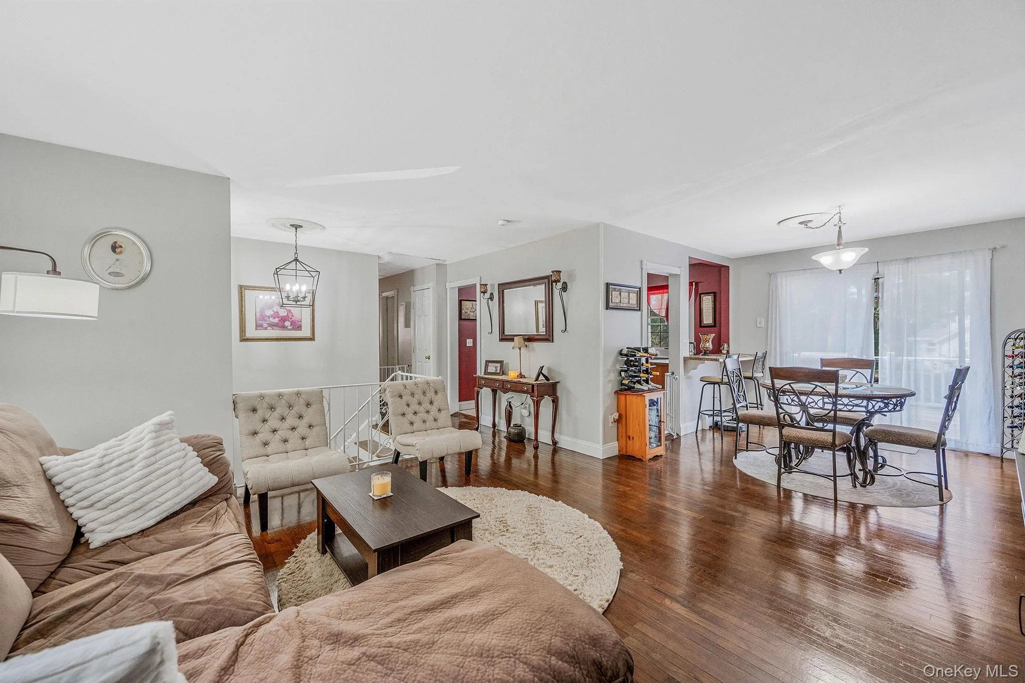 Living room with hardwood / wood-style floors and baseboards Living room with hardwood / wood-style floors and baseboards
