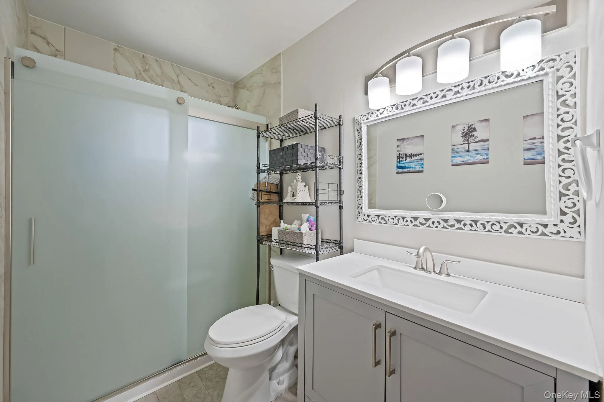 Bathroom with a stall shower, vanity, and light tile patterned floors Bathroom with a stall shower, vanity, and light tile patterned floors