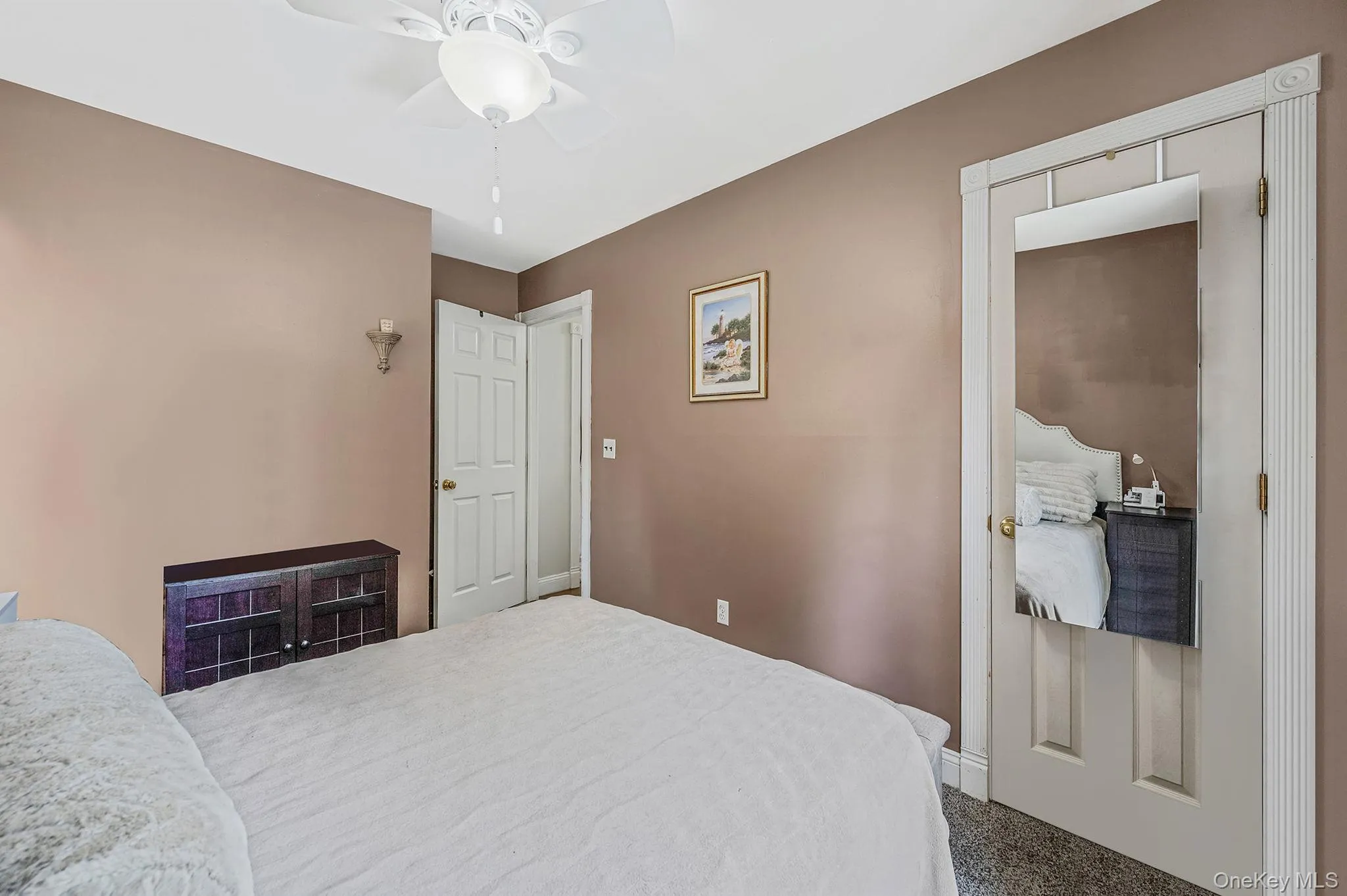 Carpeted bedroom featuring ceiling fan Carpeted bedroom featuring ceiling fan