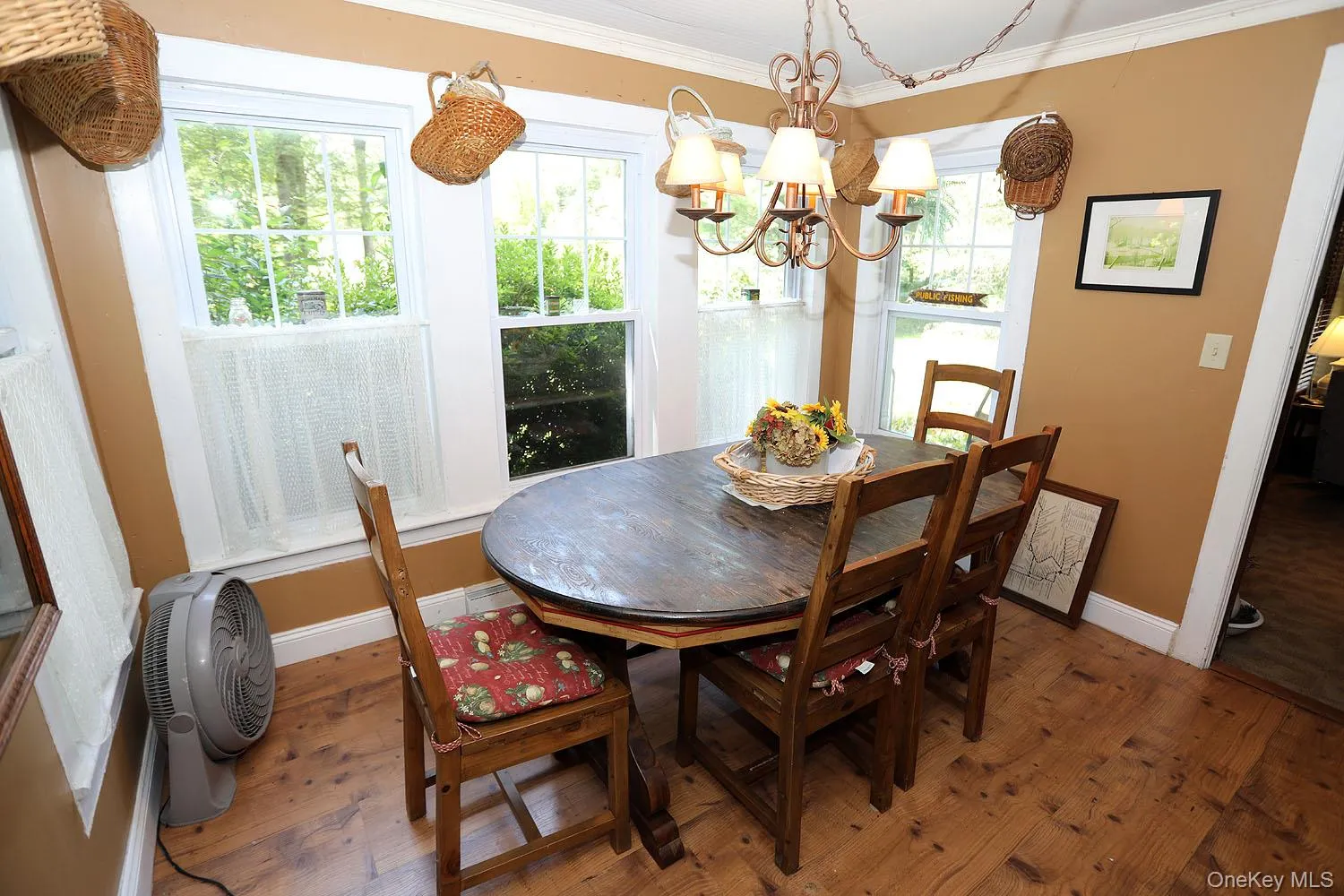 Dining room featuring hardwood / wood-style floors, crown molding, and a chandelier Dining room featuring hardwood / wood-style floors, crown molding, and a chandelier