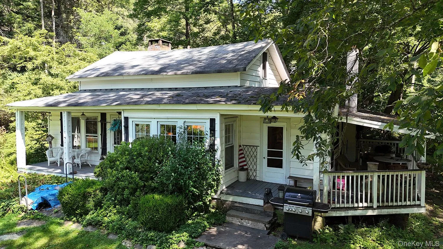 View of front facade with roof with shingles and a chimney View of front facade with roof with shingles and a chimney