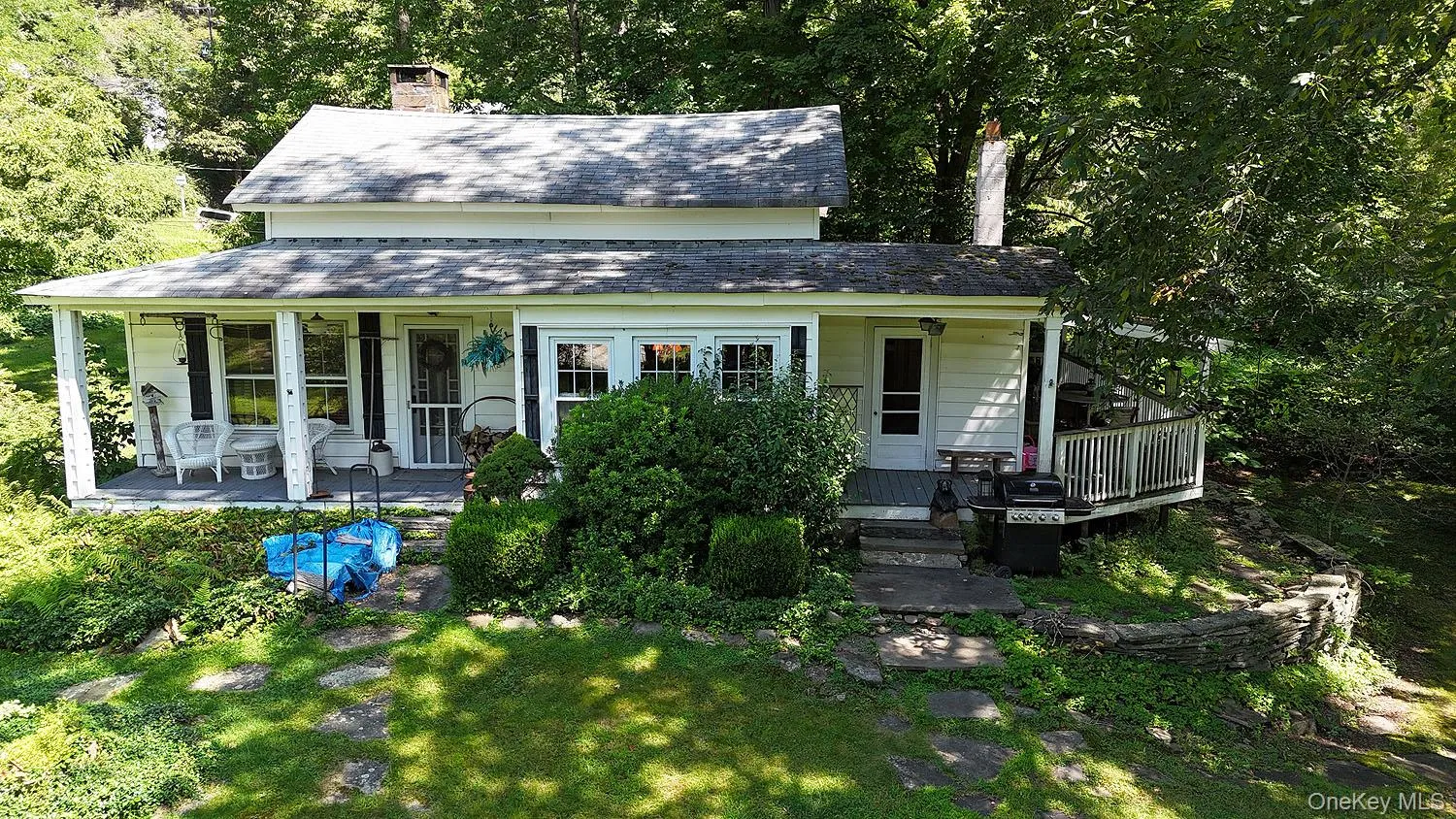 View of front of property with a shingled roof, a chimney, and covered porch View of front of property with a shingled roof, a chimney, and covered porch