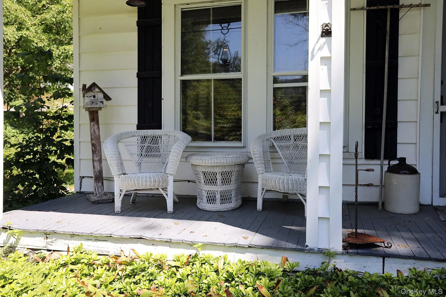 View of front covered porch featuring a wooden deck View of front covered porch featuring a wooden deck