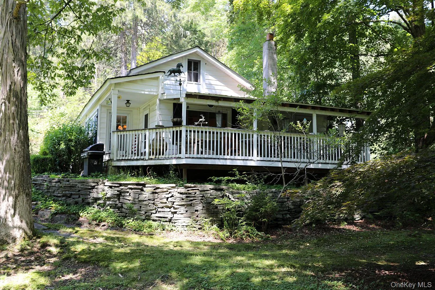 View of front of property with a wooded view View of front of property with a wooded view