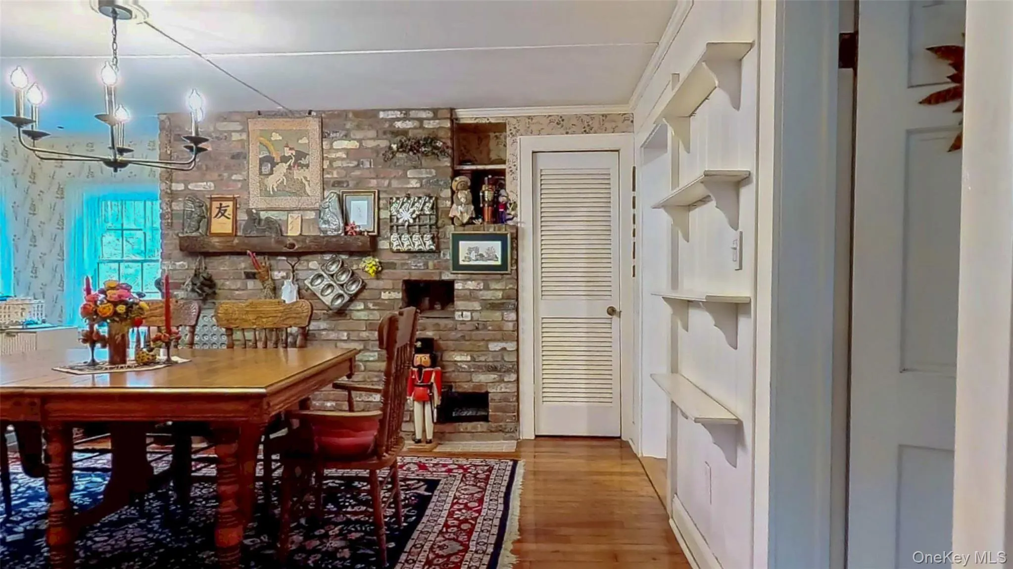 Dining space featuring a chandelier, light wood flooring, storage closet and crown molding Dining space featuring a chandelier, light wood flooring, storage closet and crown molding