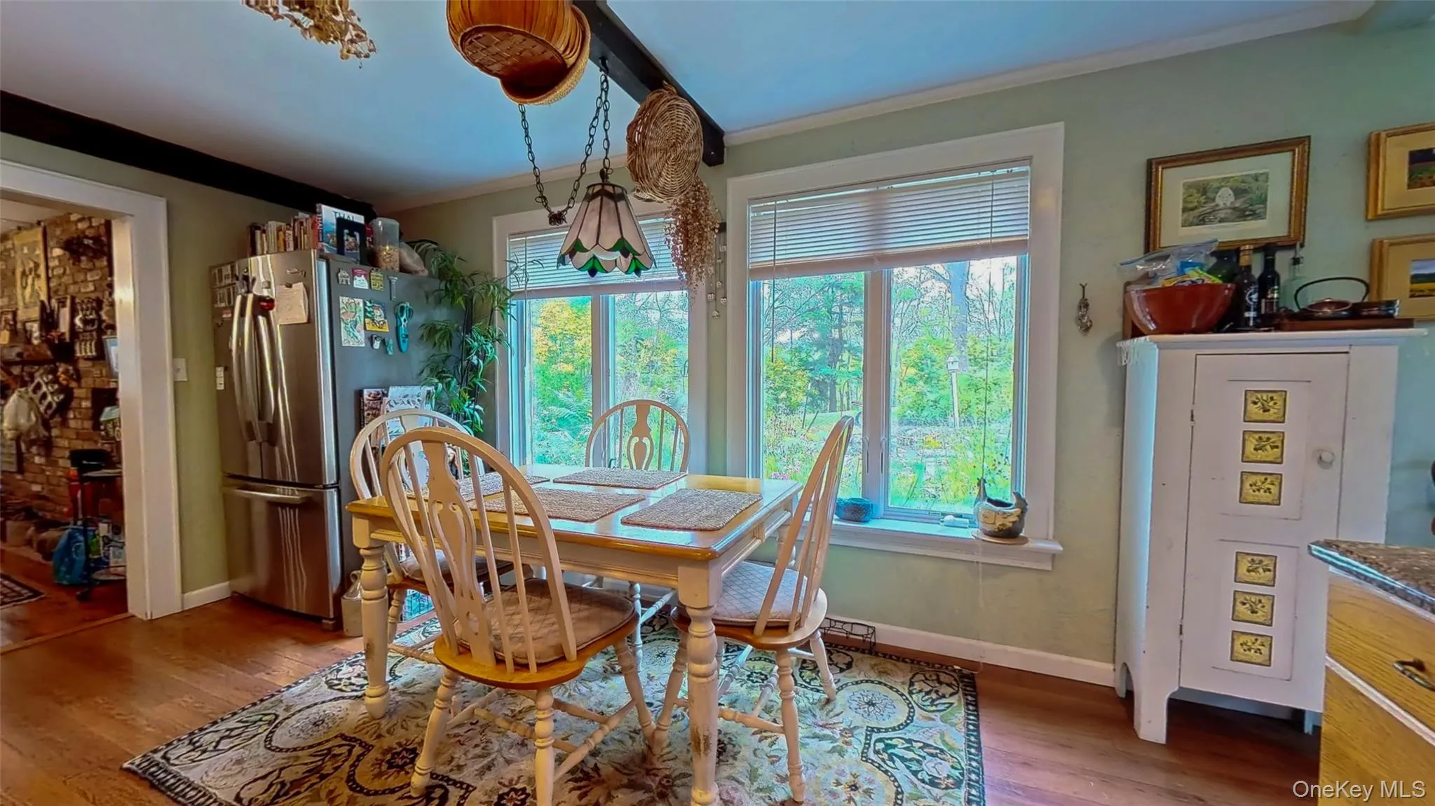 Breakfast area with oversized windows overlooking flower garden and koi pond with waterfall Breakfast area with oversized windows overlooking flower garden and koi pond with waterfall