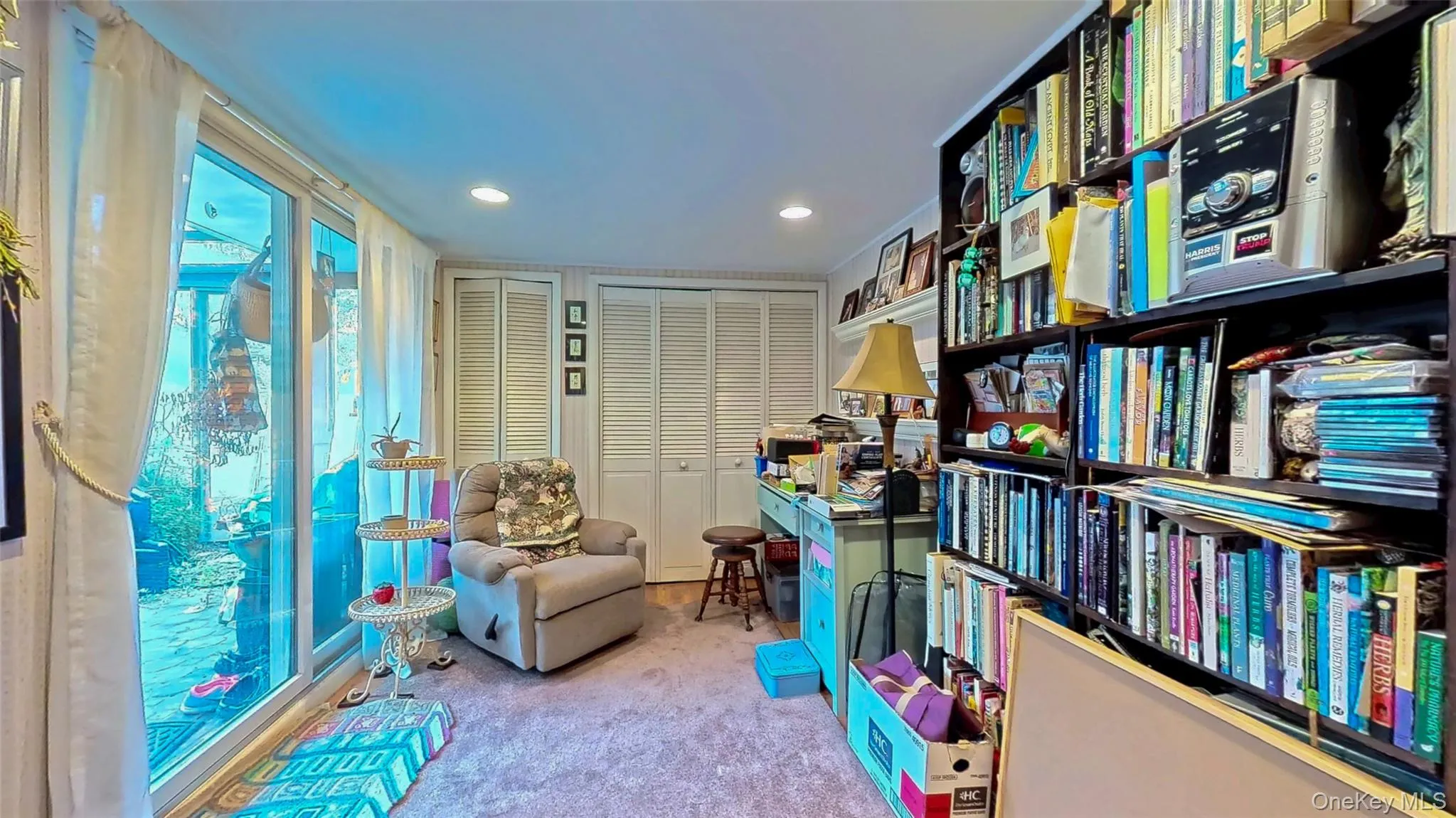Family room featuring light recessed lighting and shelving Family room featuring light recessed lighting and shelving