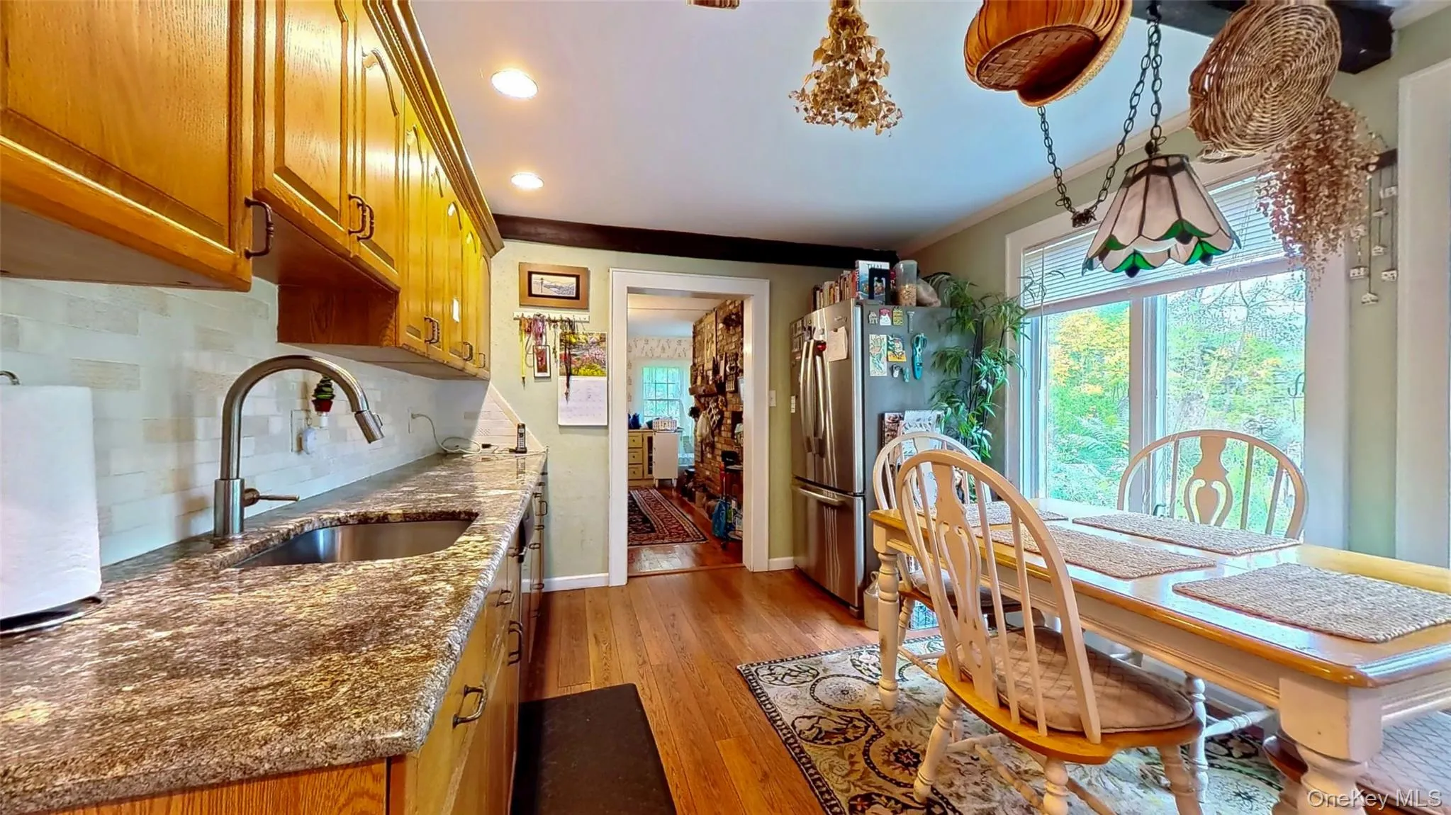 Eat in kitchen featuring light wood floors, granite countertop, and recessed lighting Eat in kitchen featuring light wood floors, granite countertop, and recessed lighting