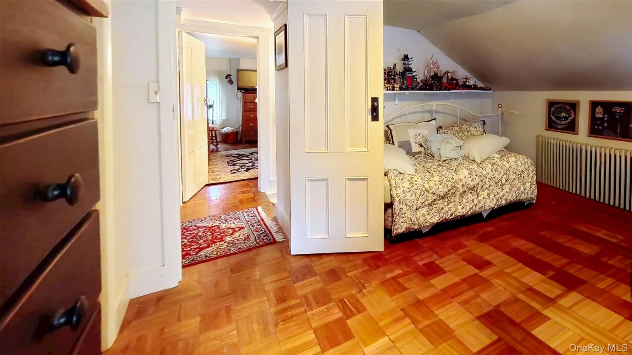 Bedroom featuring radiator heating unit and Parque floor Bedroom featuring radiator heating unit and Parque floor
