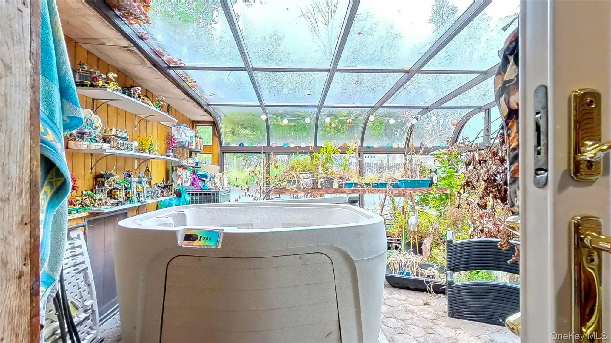 Sunroom featuring hot tub stone floor and access to the inground pool and patio Sunroom featuring hot tub stone floor and access to the inground pool and patio