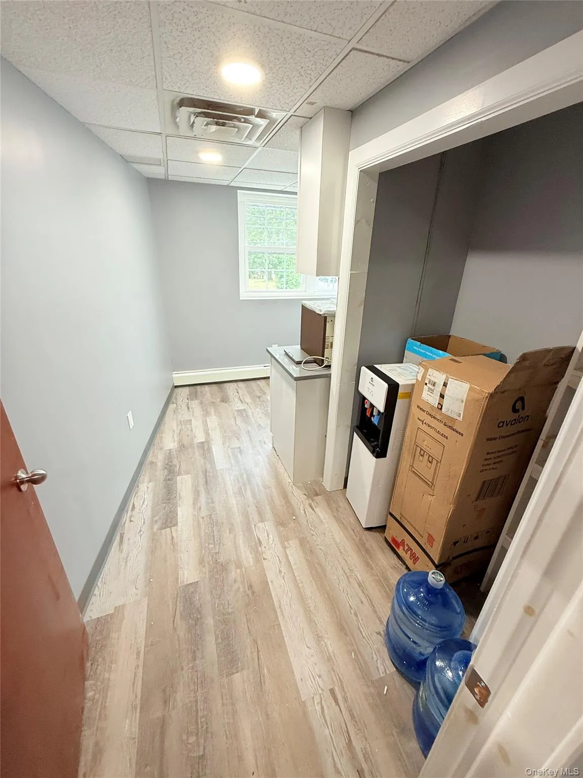 Washroom with light wood-style flooring and baseboards Washroom with light wood-style flooring and baseboards