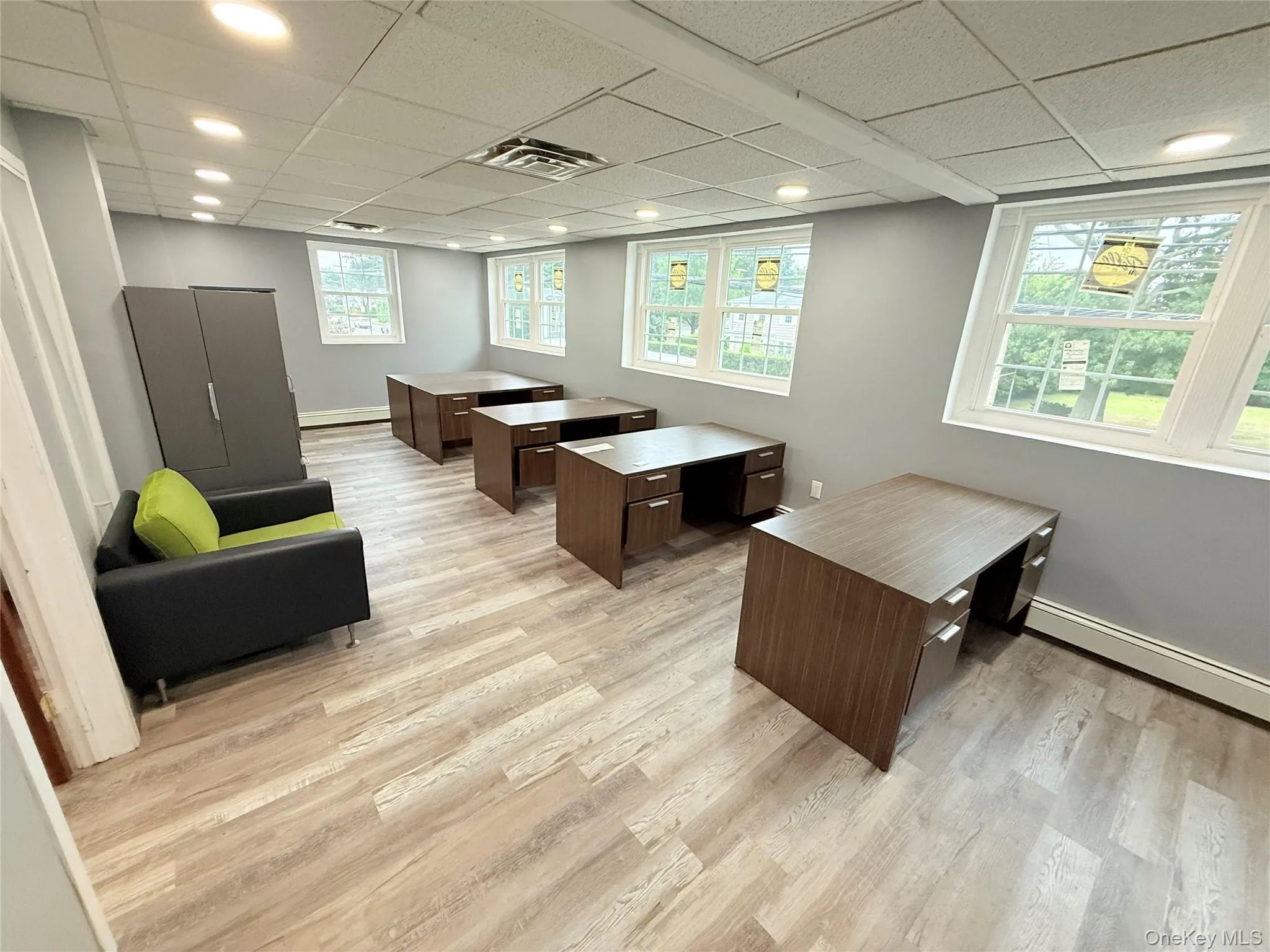 Home office with a paneled ceiling, light wood finished floors, and recessed lighting Home office with a paneled ceiling, light wood finished floors, and recessed lighting