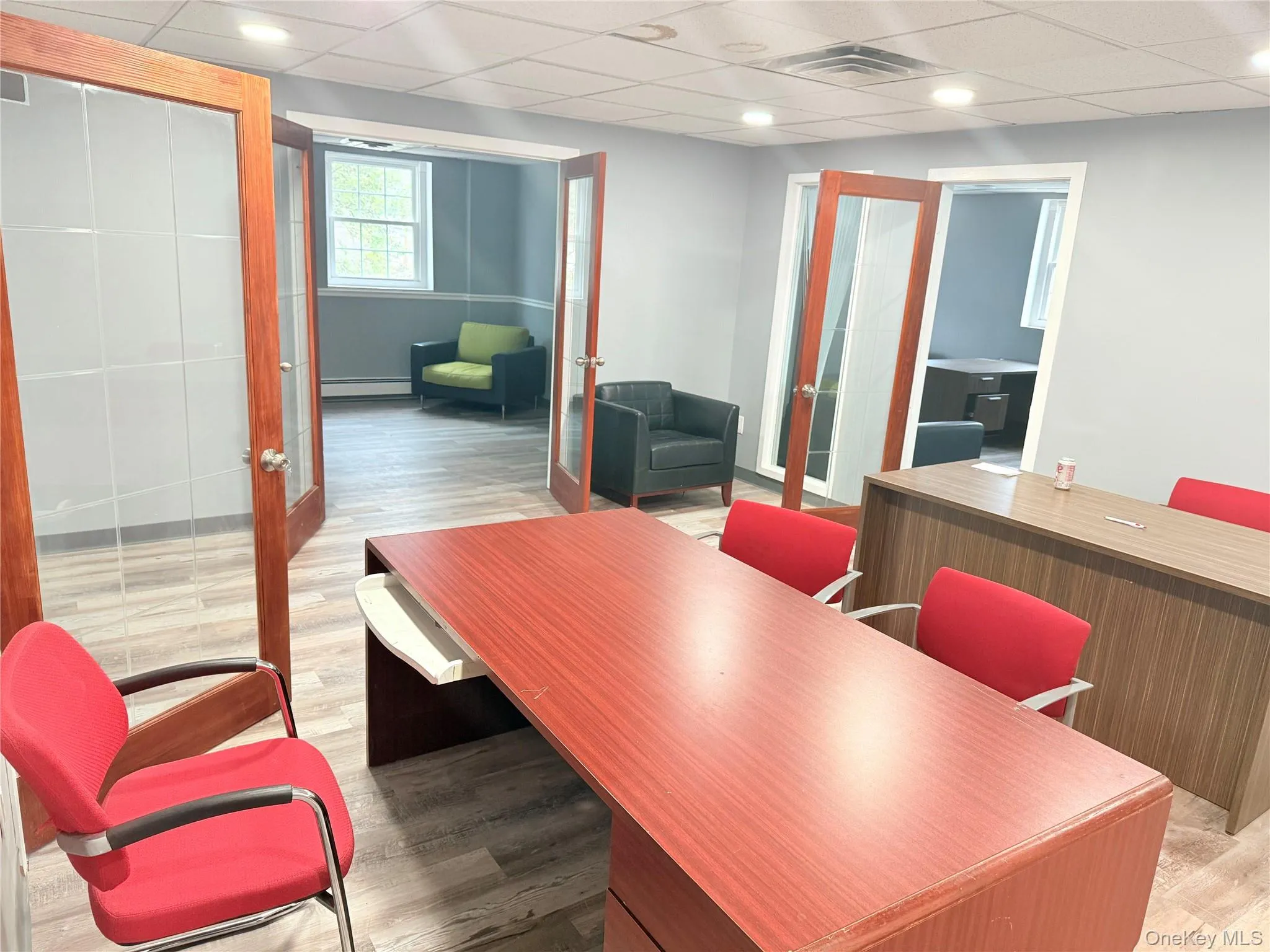 Home office featuring a drop ceiling, french doors, light wood-style floors, recessed lighting, and baseboard heating Home office featuring a drop ceiling, french doors, light wood-style floors, recessed lighting, and baseboard heating