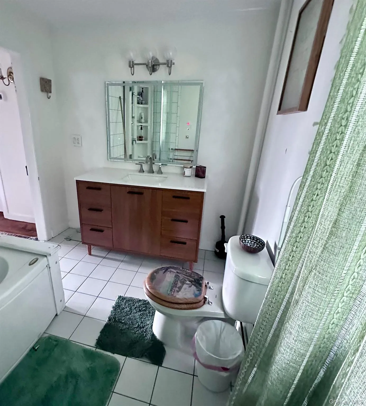 Full bathroom featuring light tile patterned flooring, vanity, and a bath Full bathroom featuring light tile patterned flooring, vanity, and a bath